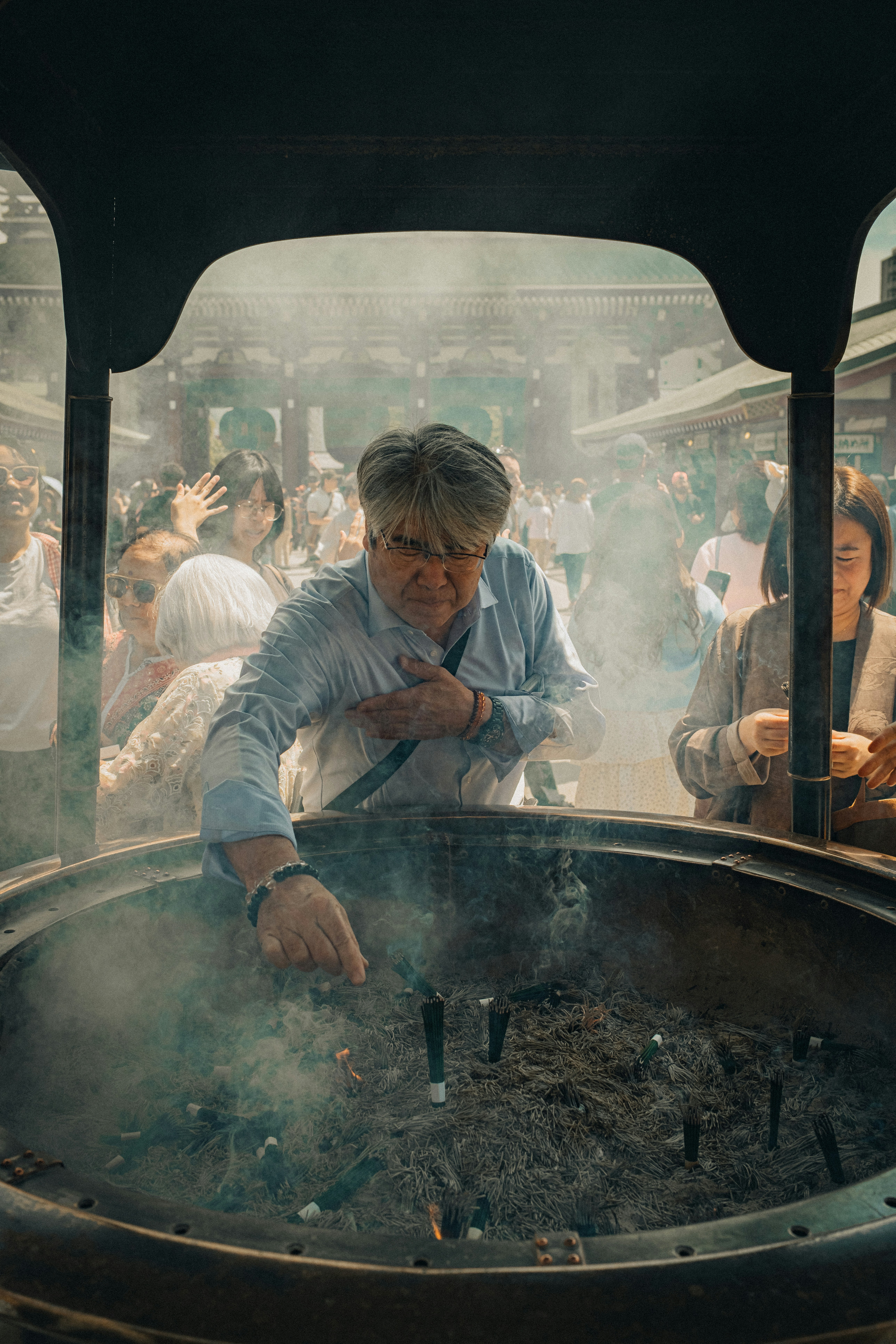 Man praying at a large incense burner
