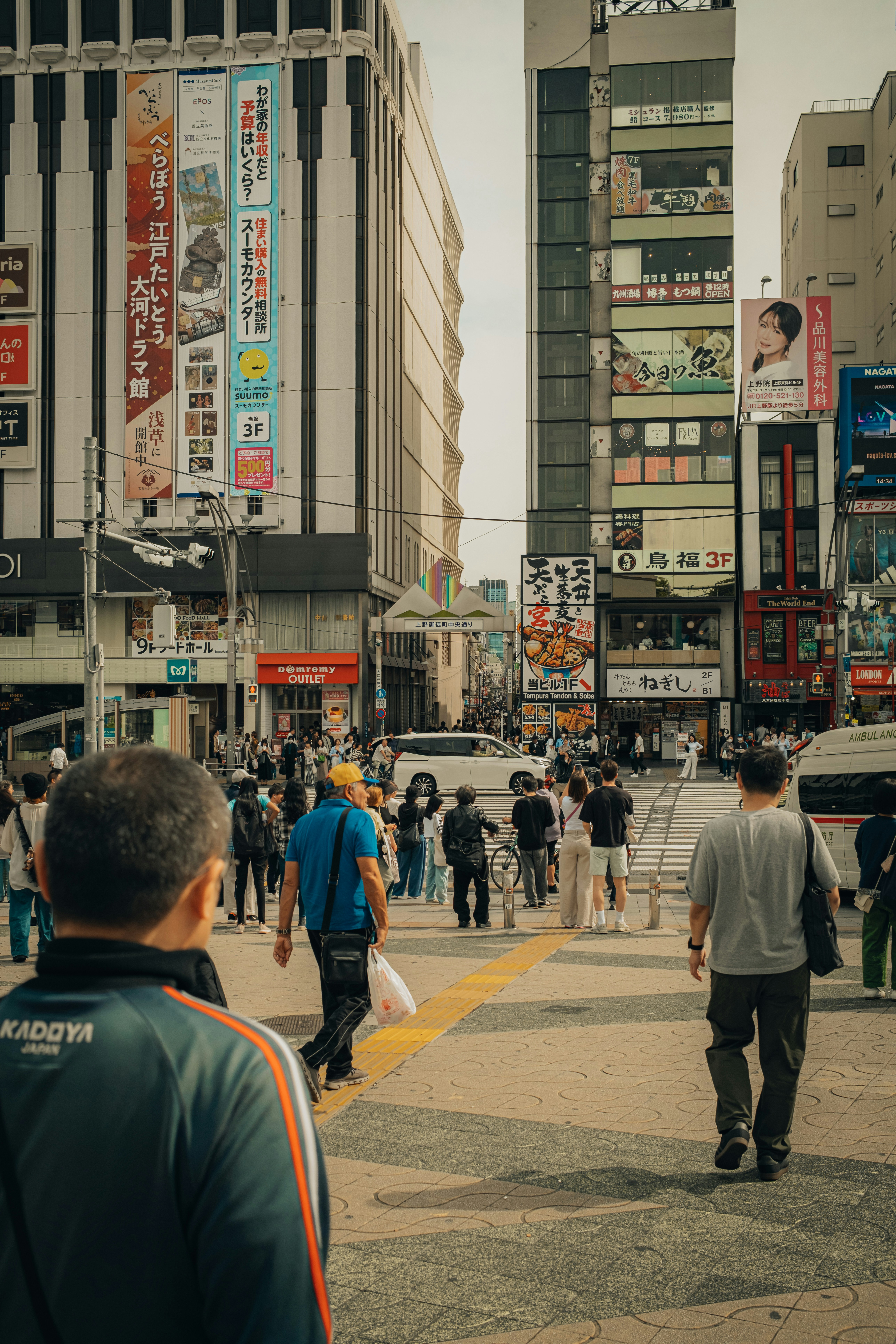 People crossing a busy street in a japanese city.