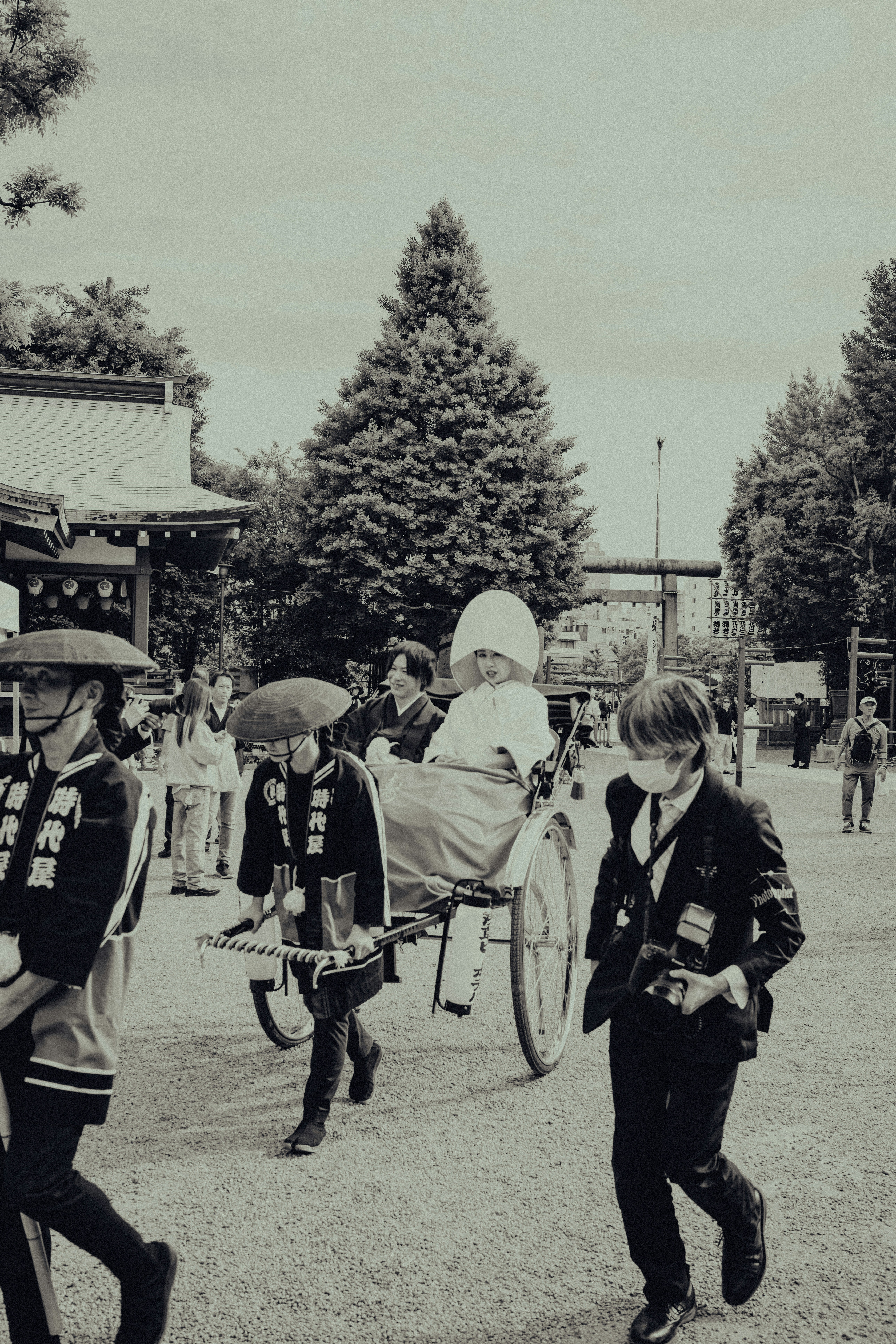 People in traditional japanese attire pulling a rickshaw