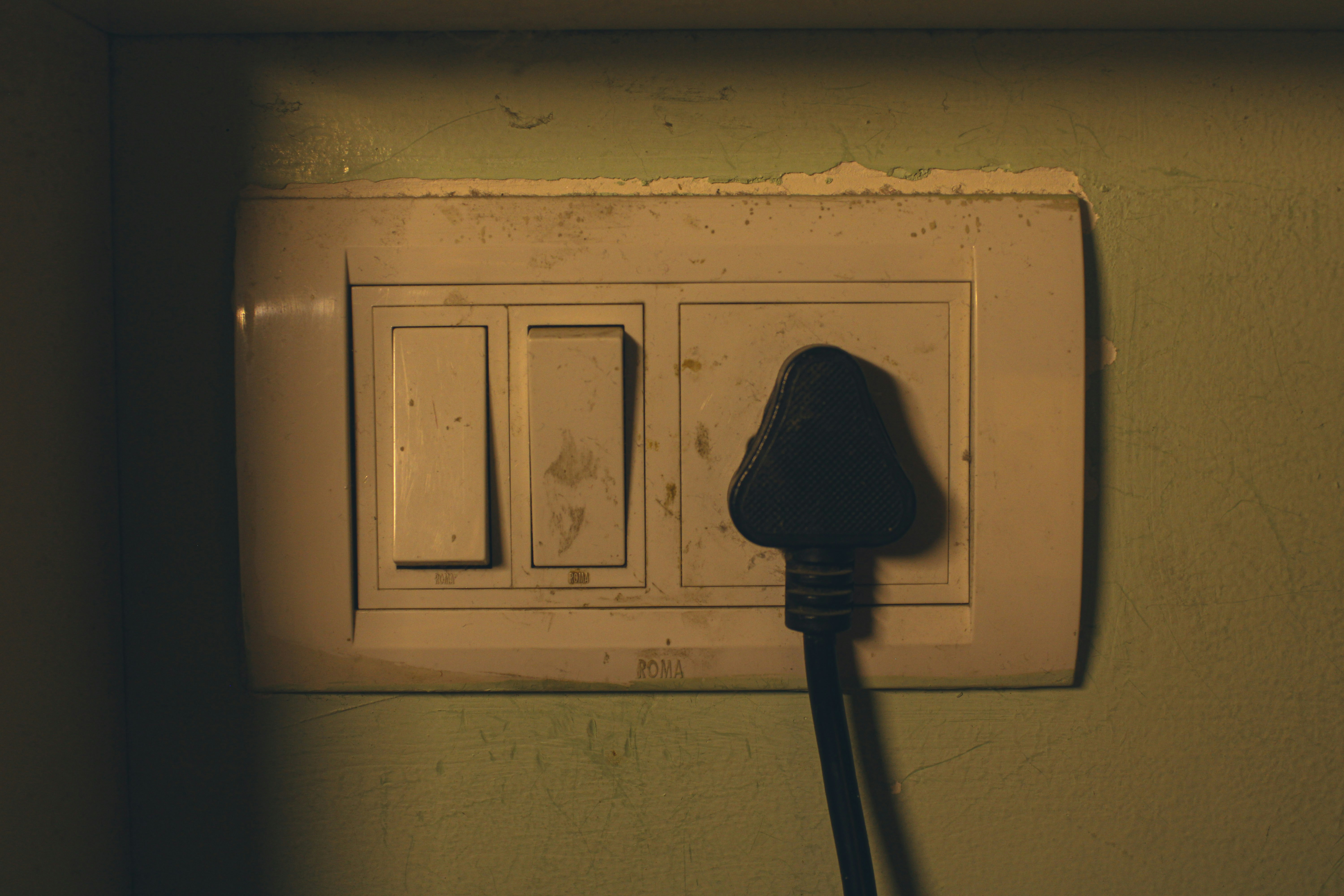 a charred or burnt electrical outlet showing black soot marks on the wall - emergency electrician