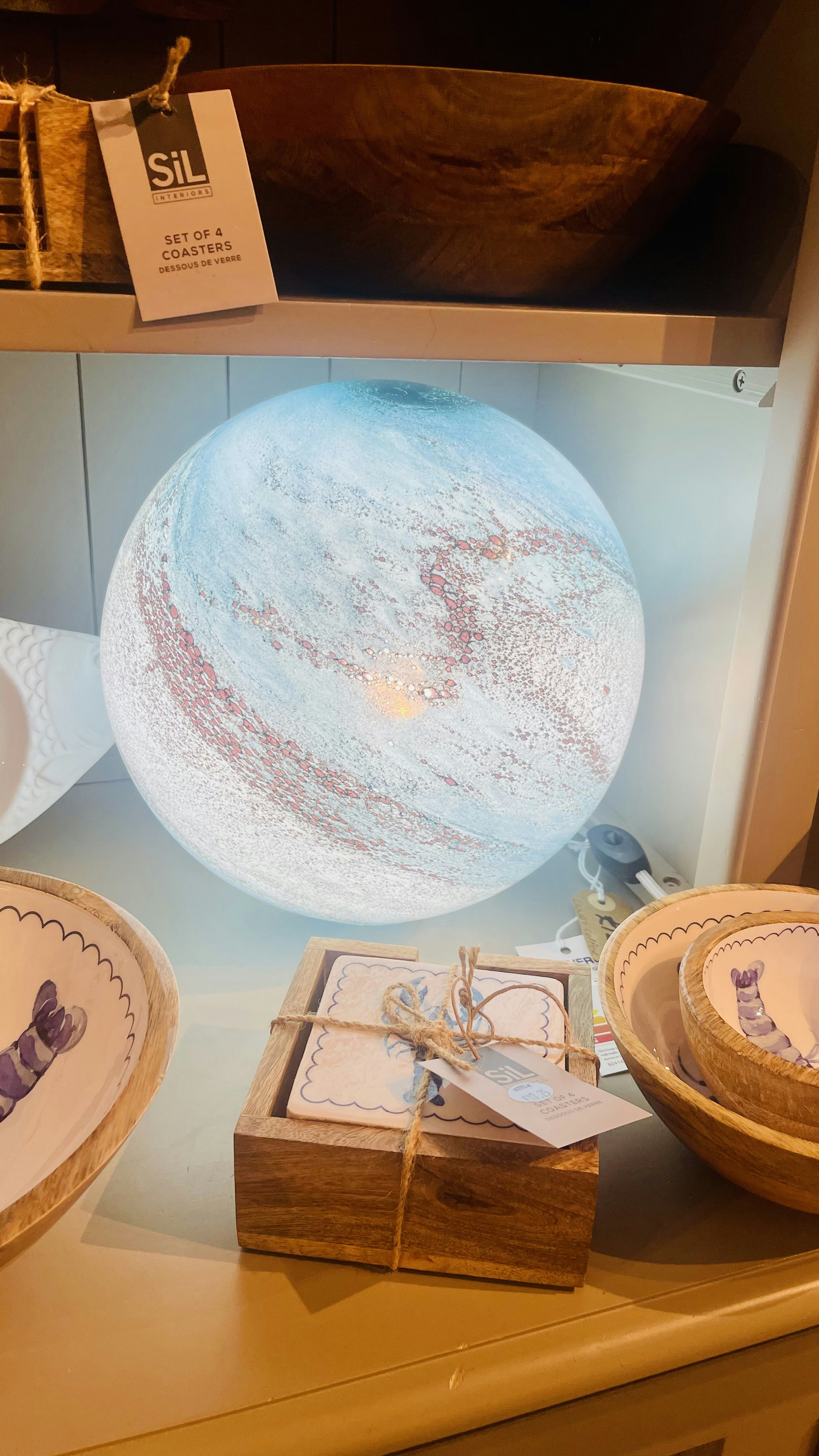 A globe-shaped lamp with swirling blue and white patterns.