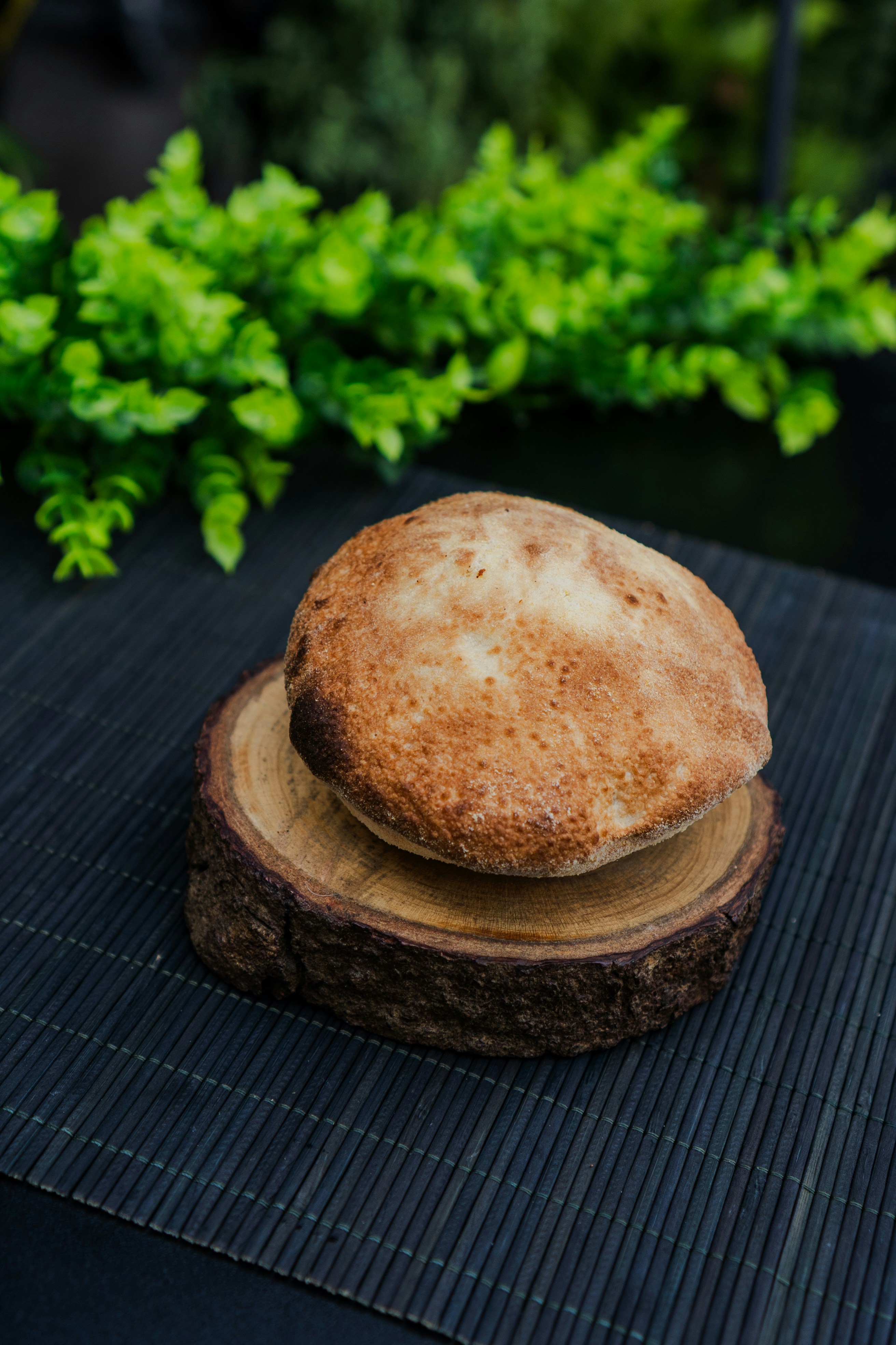 A round pita bread on a wooden stand