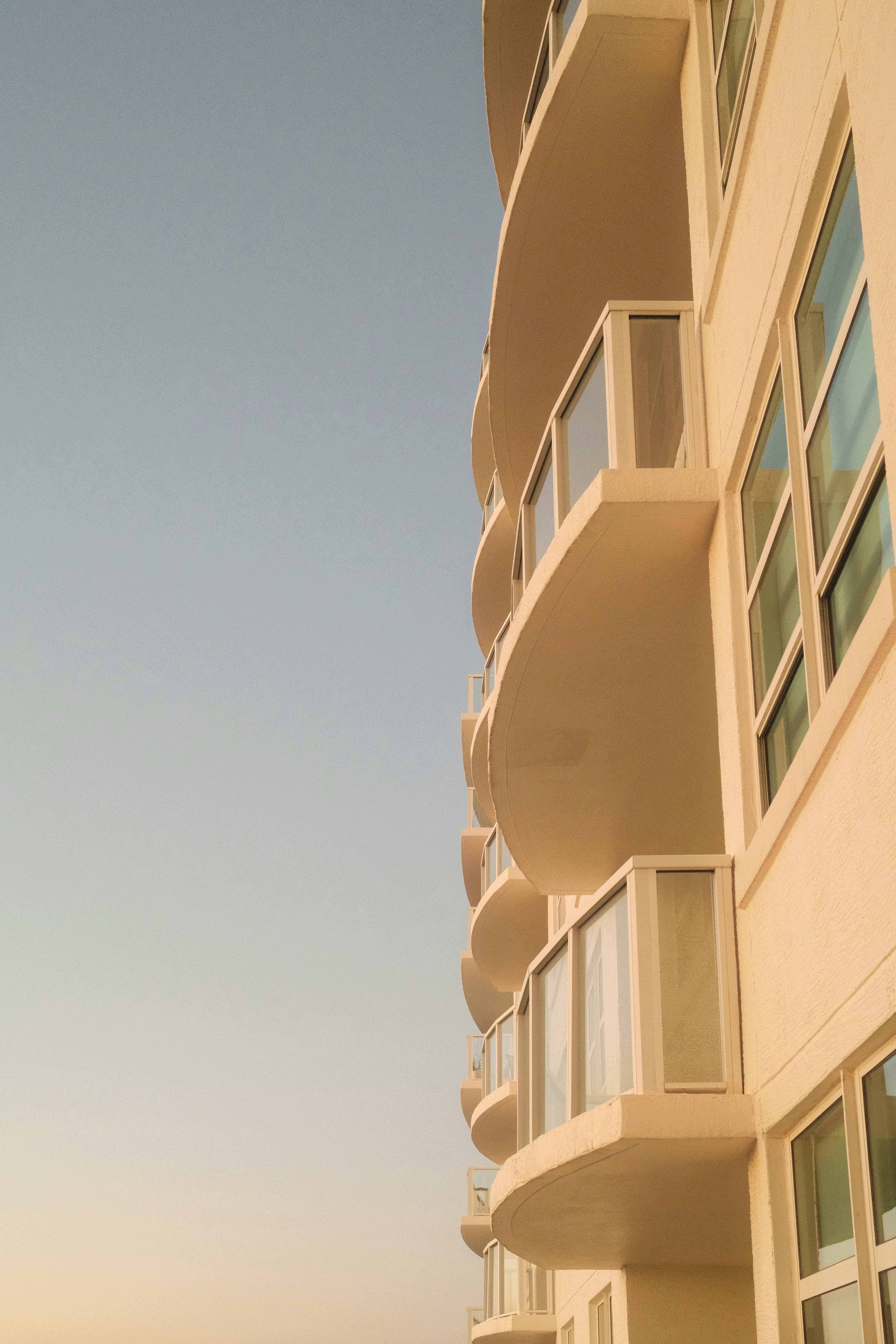 Modern building with curved balconies against clear sky
