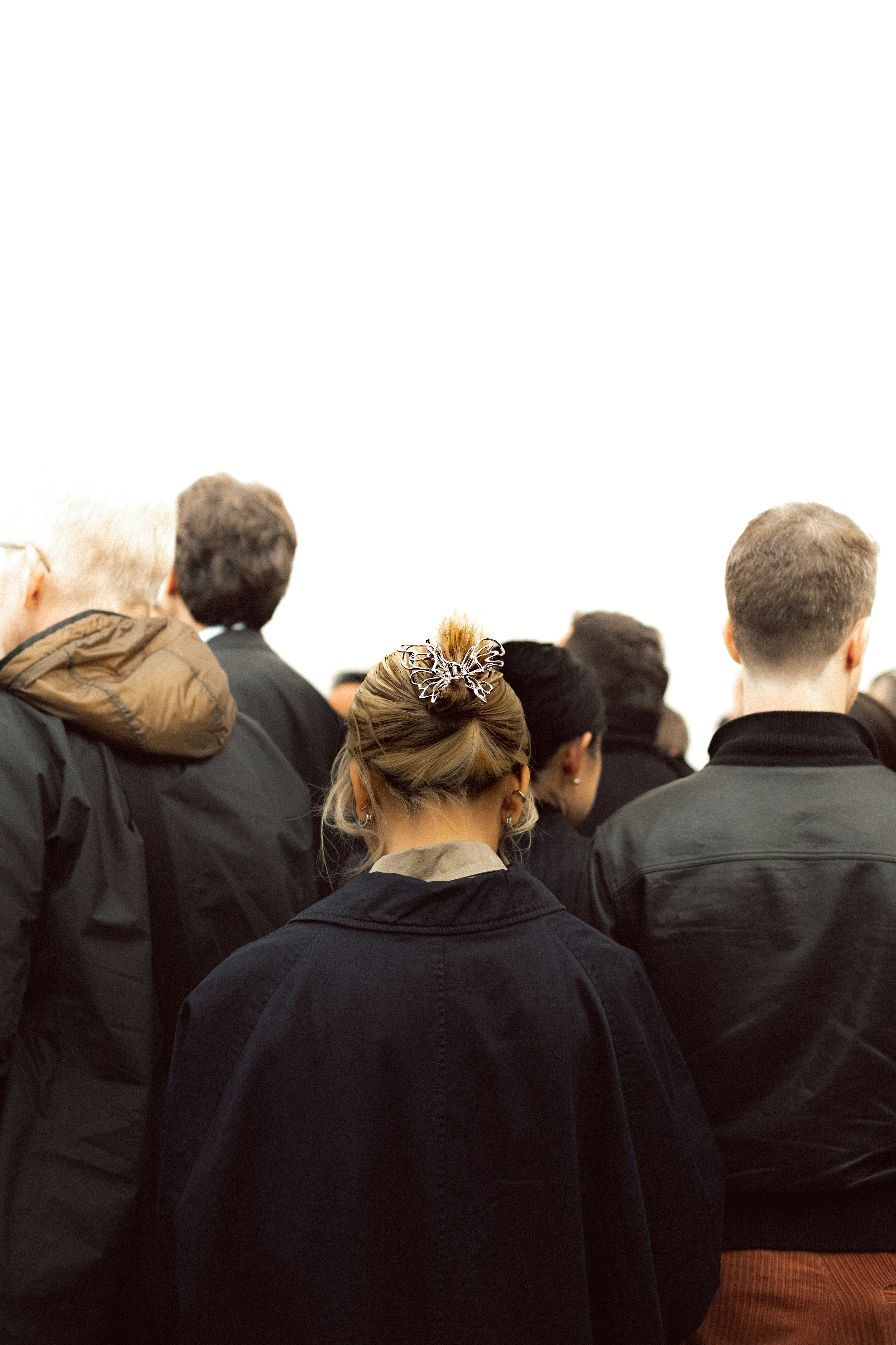 People gathered together seen from behind.