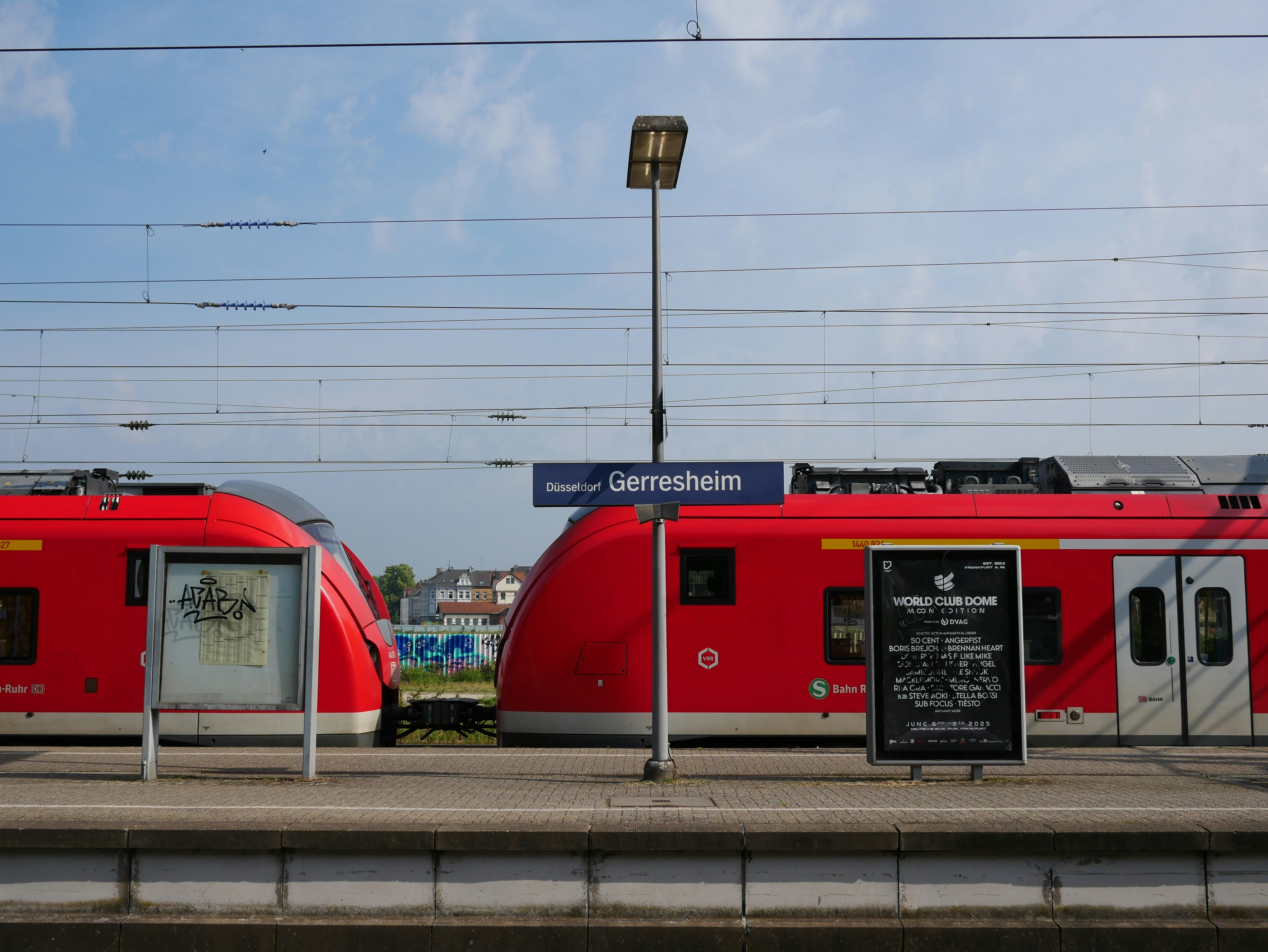 Two red trains at a station platform