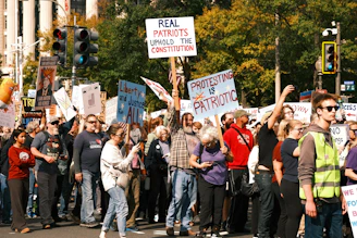 Protesters hold signs at a rally