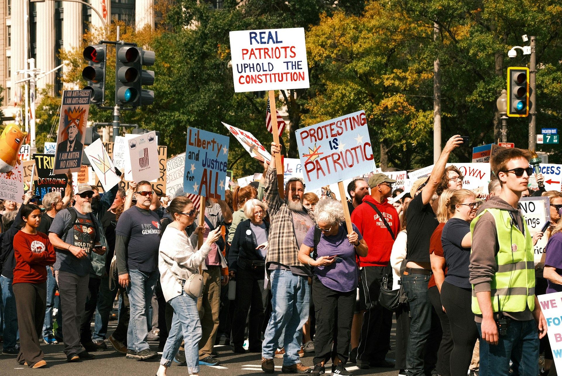 Protesters hold signs at a rally