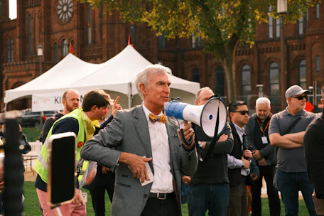 Man with megaphone speaking to a crowd