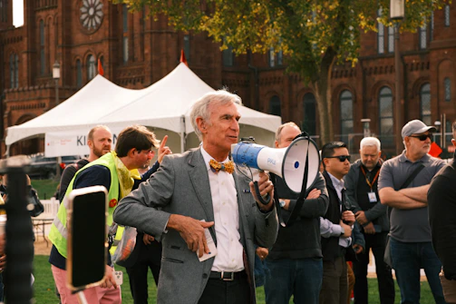 Man with megaphone speaking to a crowd