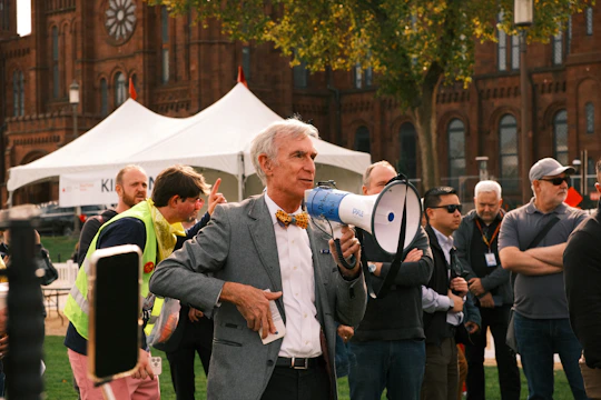 Man with megaphone speaking to a crowd