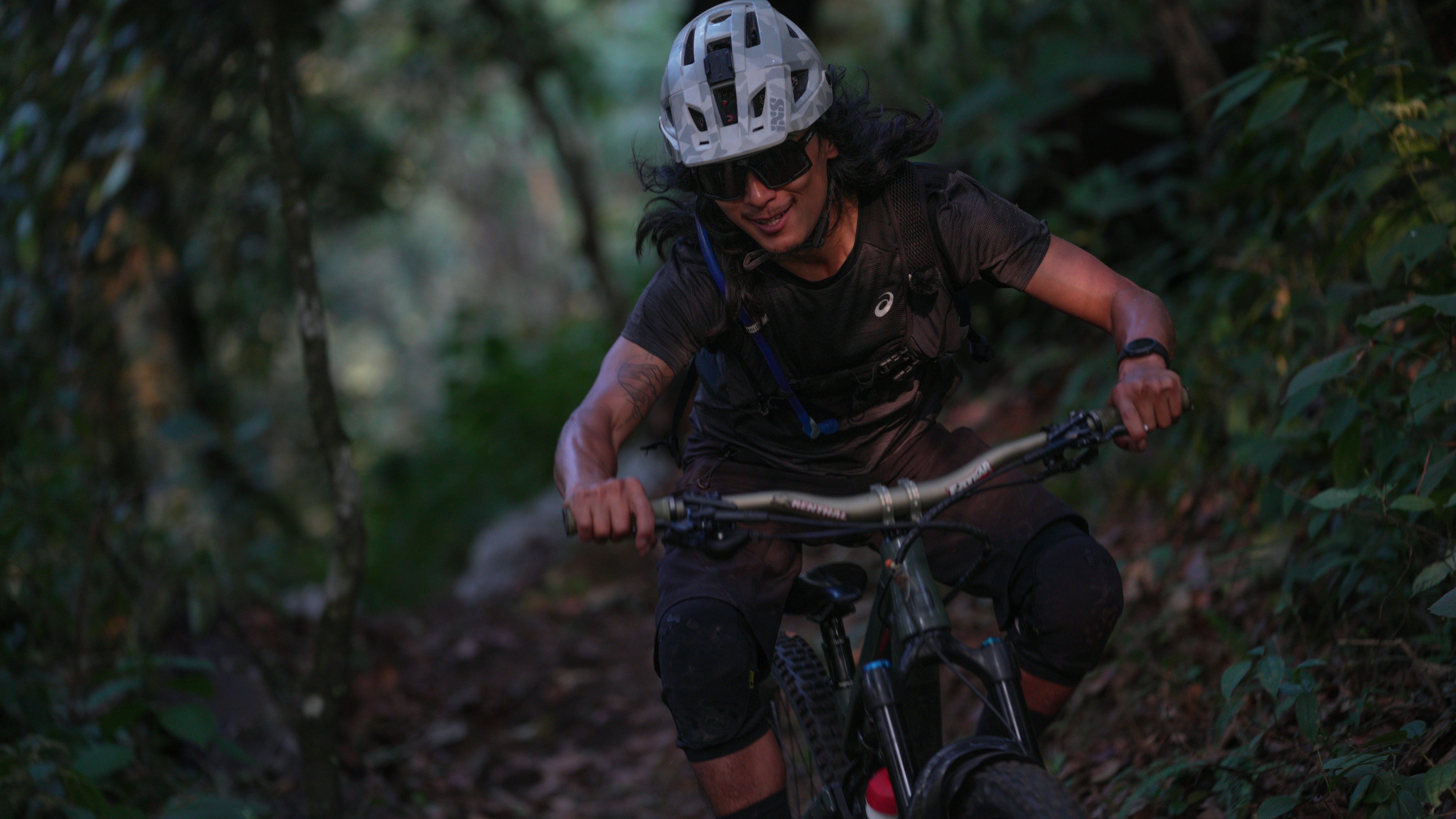 Man riding a mountain bike on a forest trail