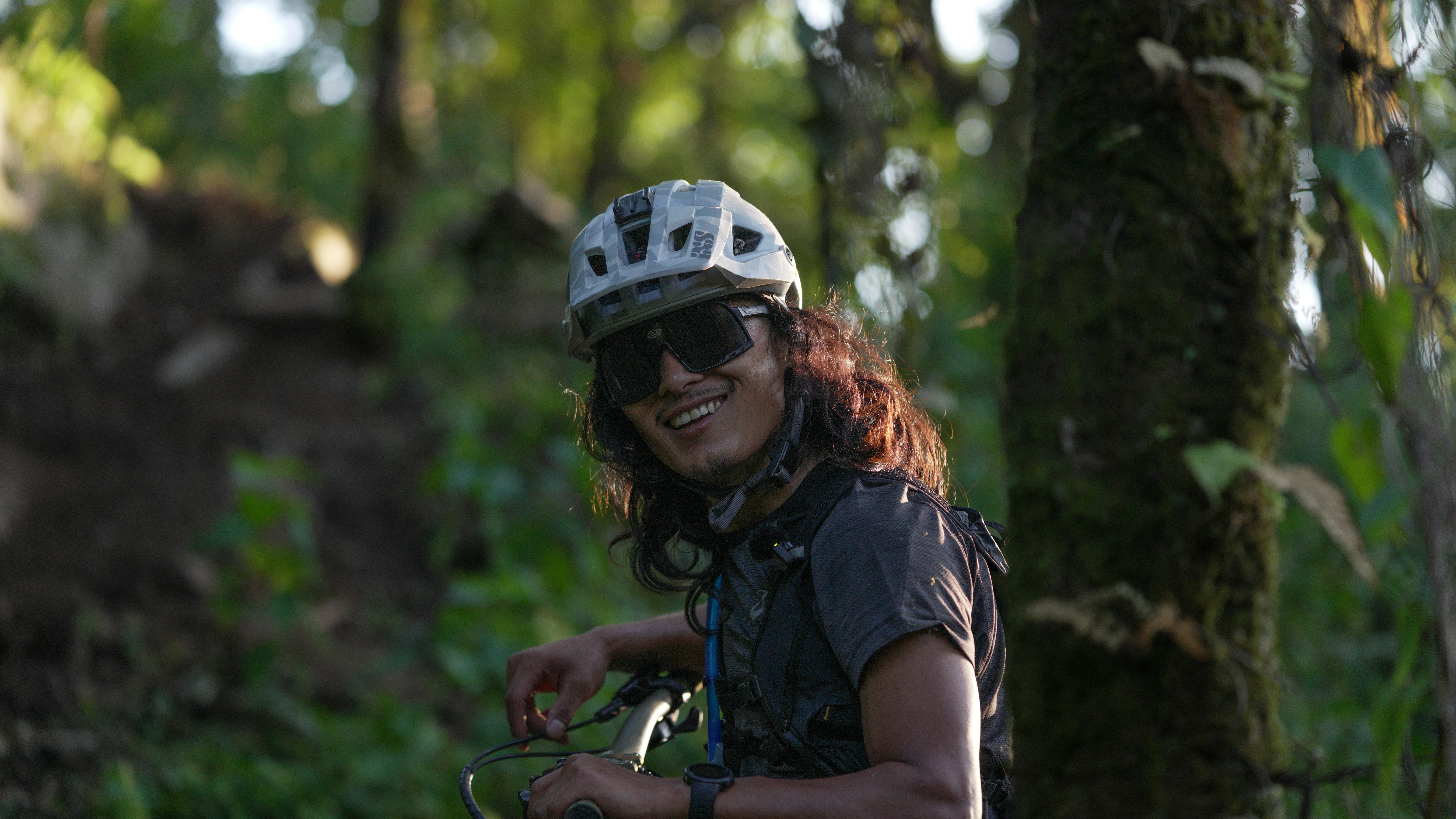 Smiling mountain biker in a forest