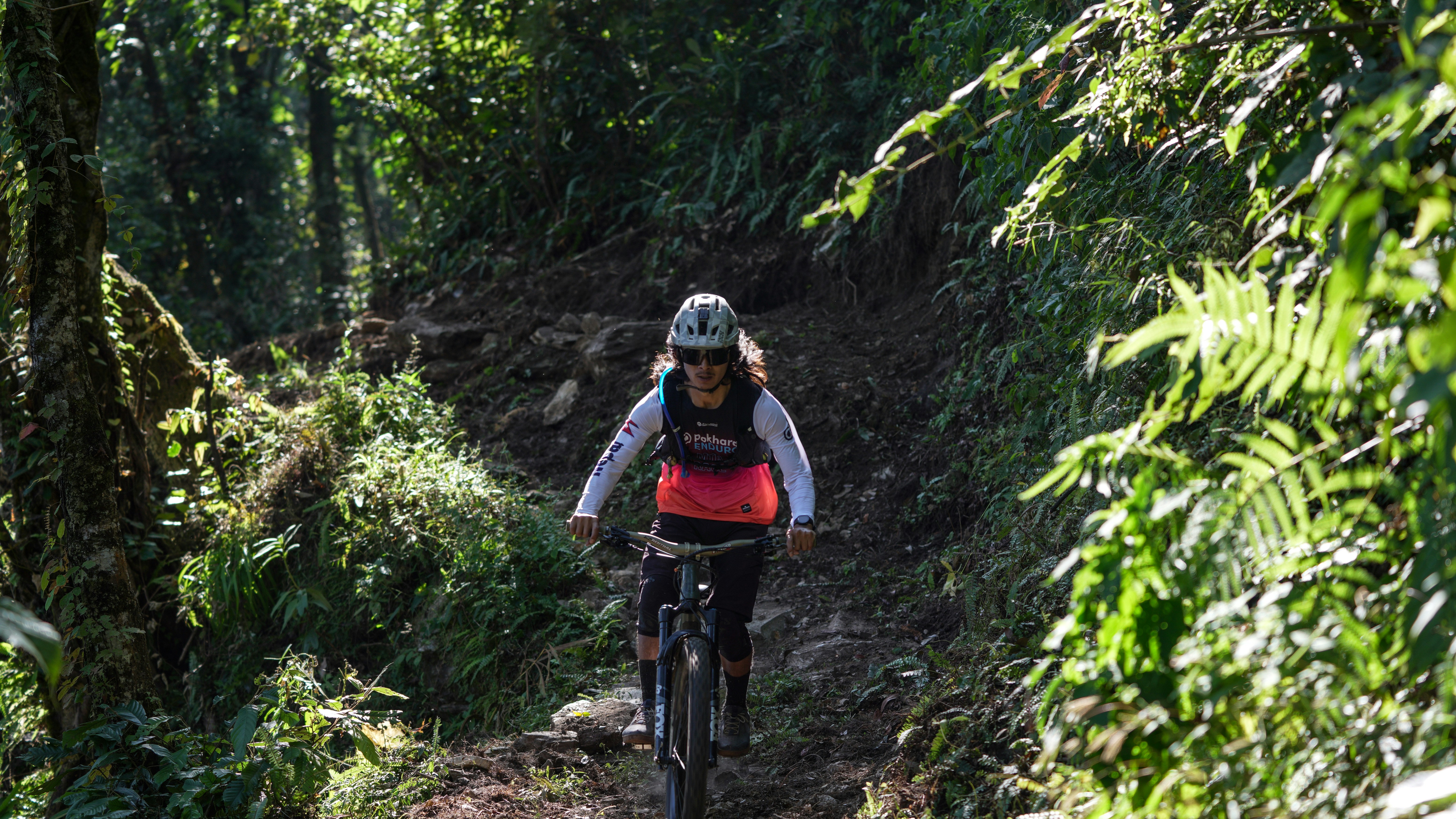 Woman riding a mountain bike on a forest trail