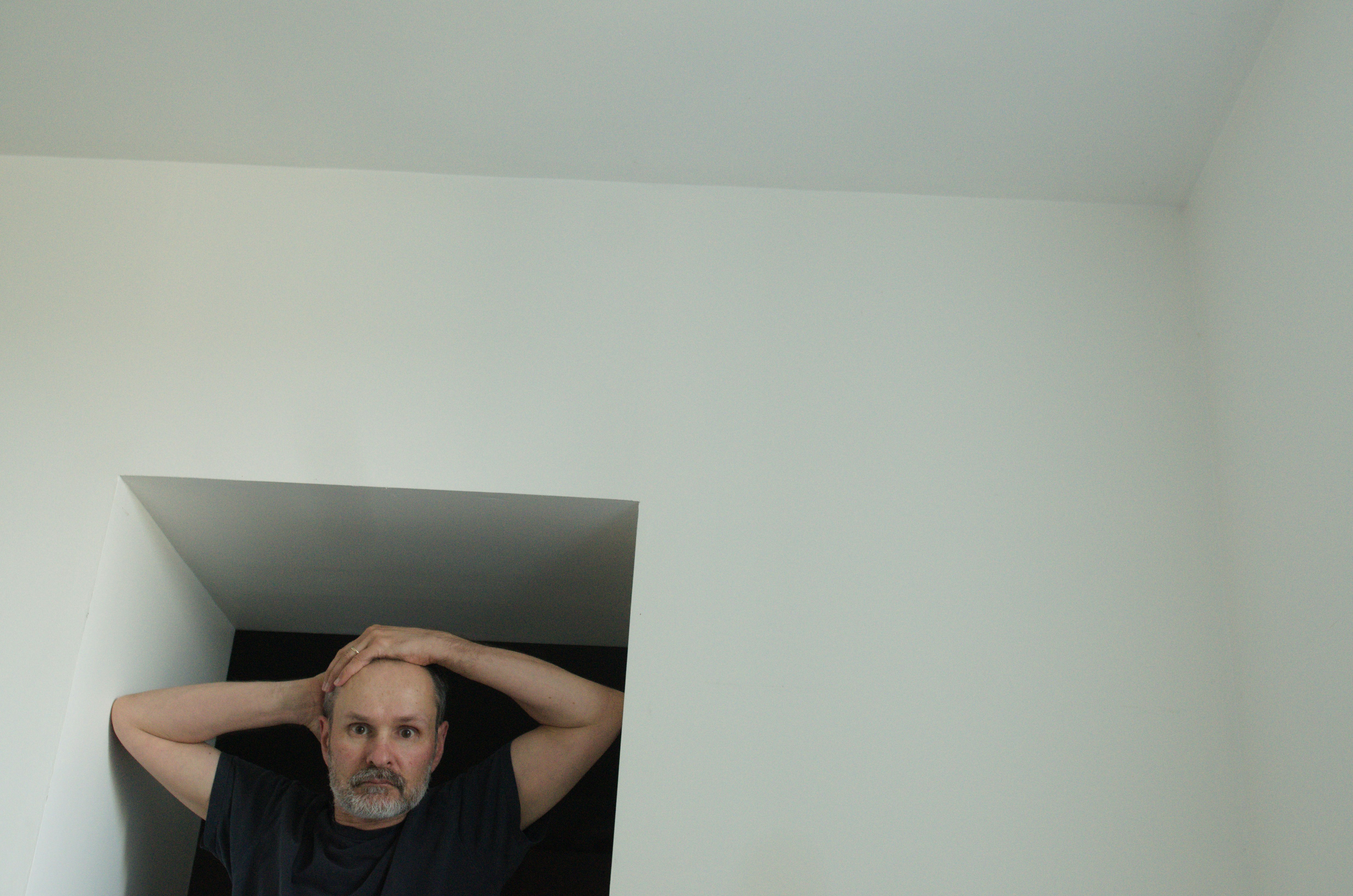 A middle-aged man with a contemplative expression, reflecting emotional and intimacy concerns