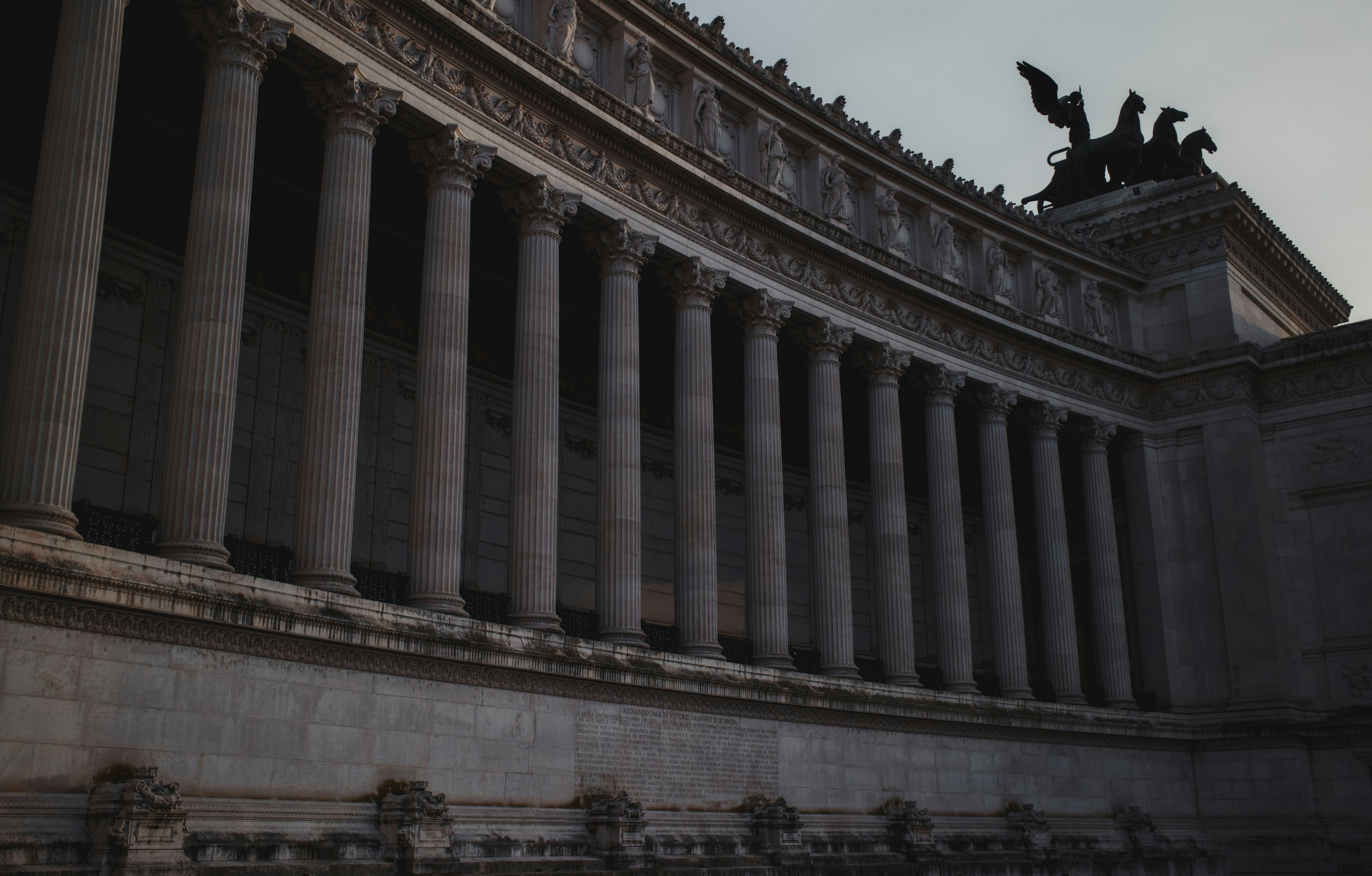 Grand neoclassical building with many columns and statues.