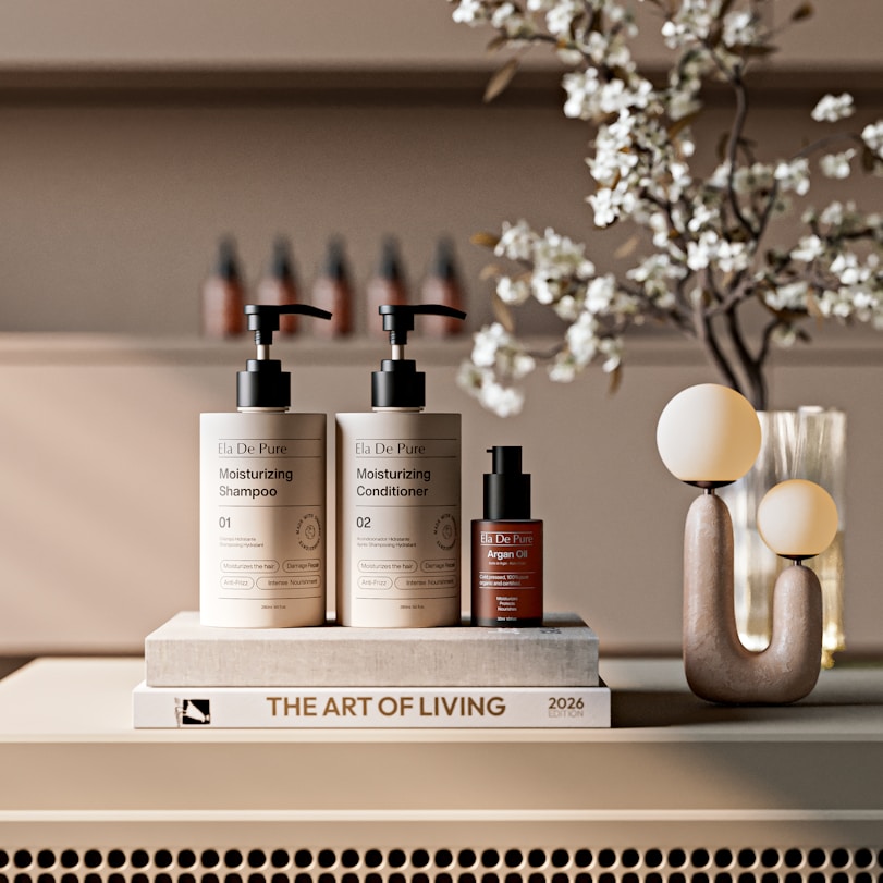 Shampoo, conditioner, and serum bottles on a book.