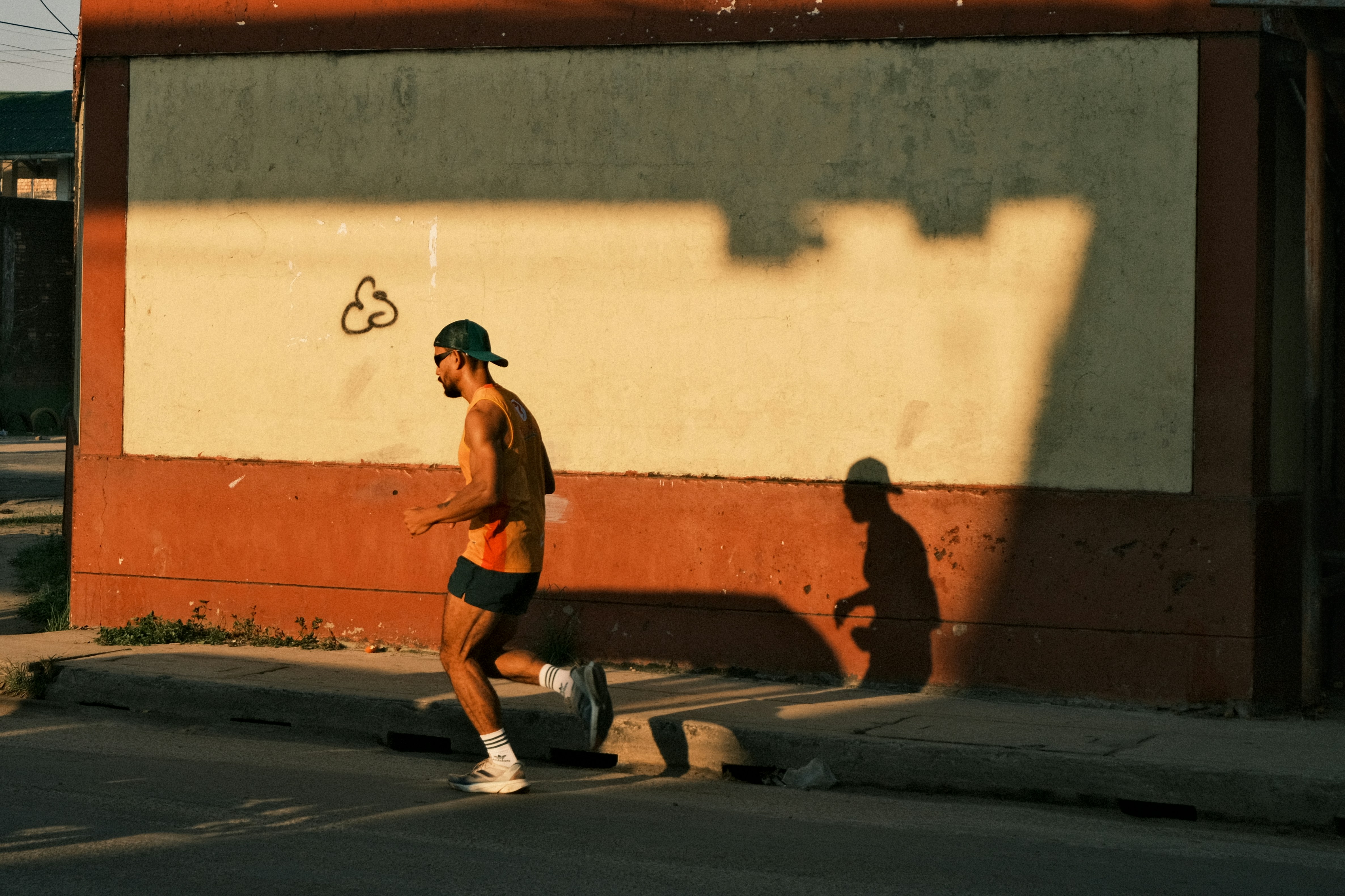 Jogger with shadow on wall