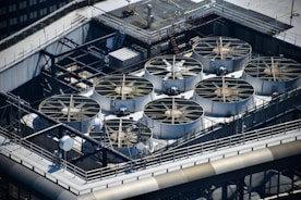 Industrial cooling fans on a rooftop.