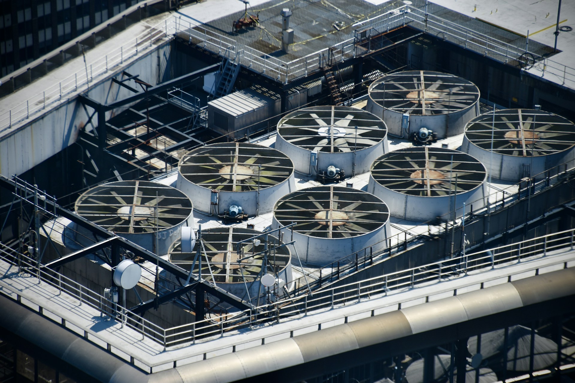Industrial cooling fans on a rooftop.