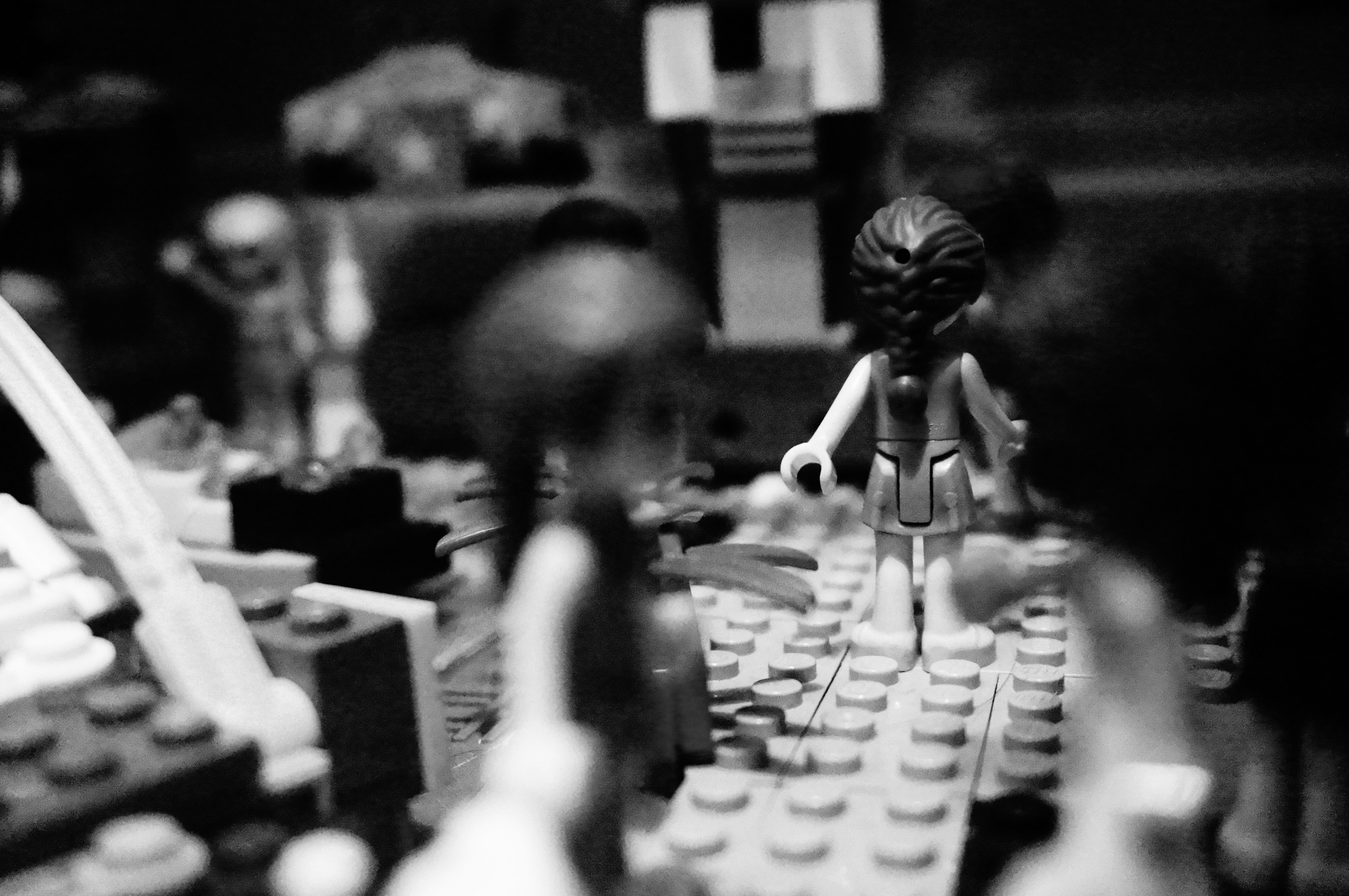 Black and white scene of lego figures in a landscape.