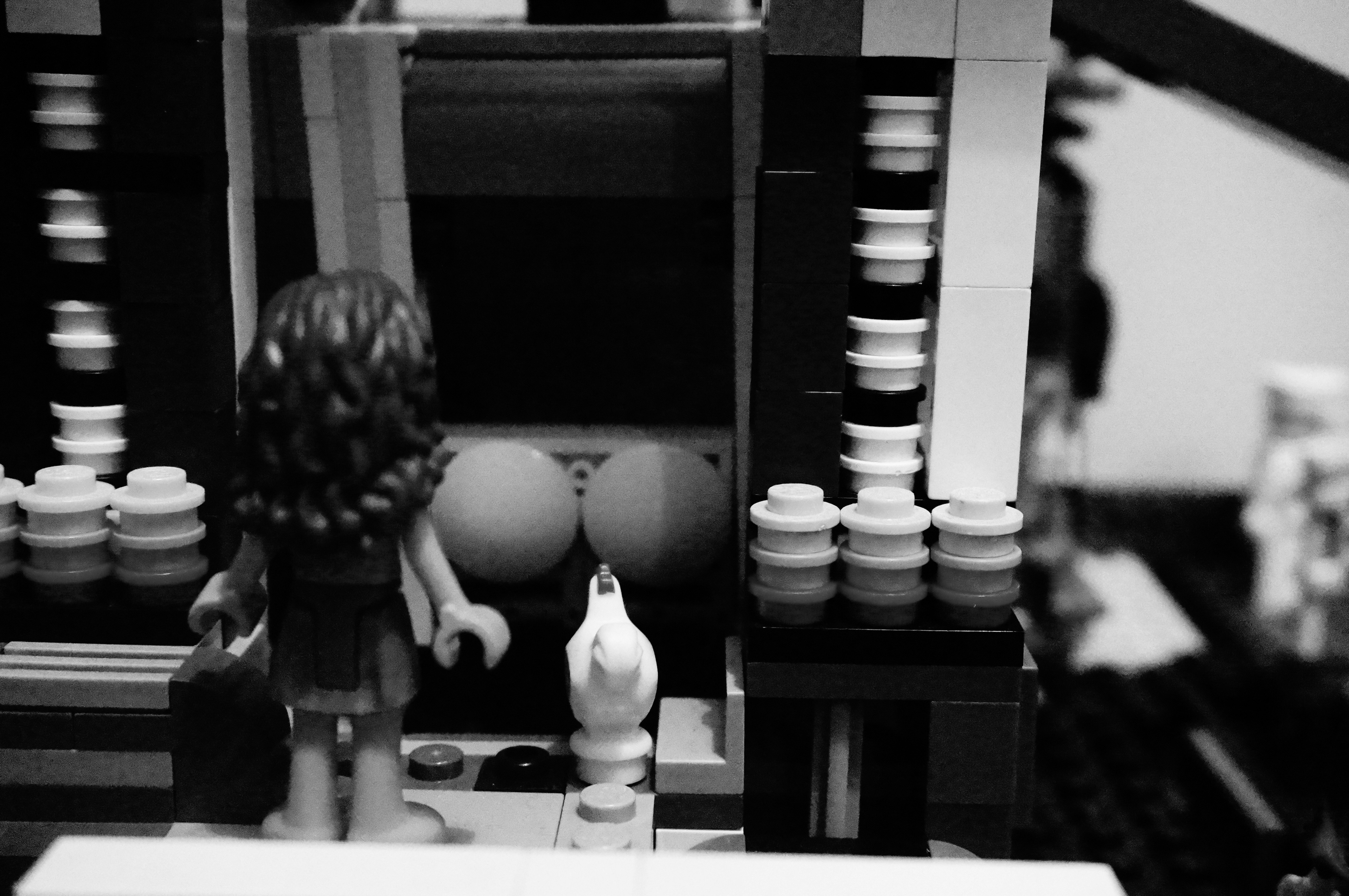 Lego figure stands before a diorama with a bird.