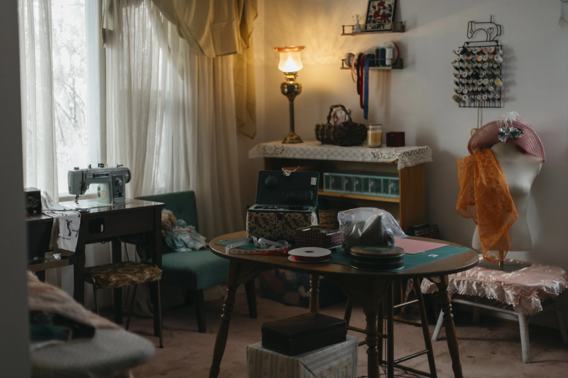 A sewing room with a vintage sewing machine and supplies.