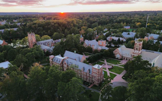 Campus buildings surrounded by trees at sunset