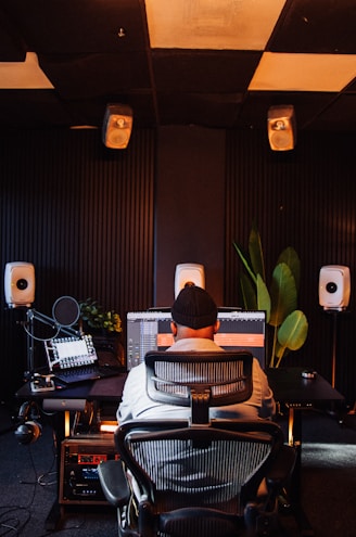 Person working at computer in sound recording studio.