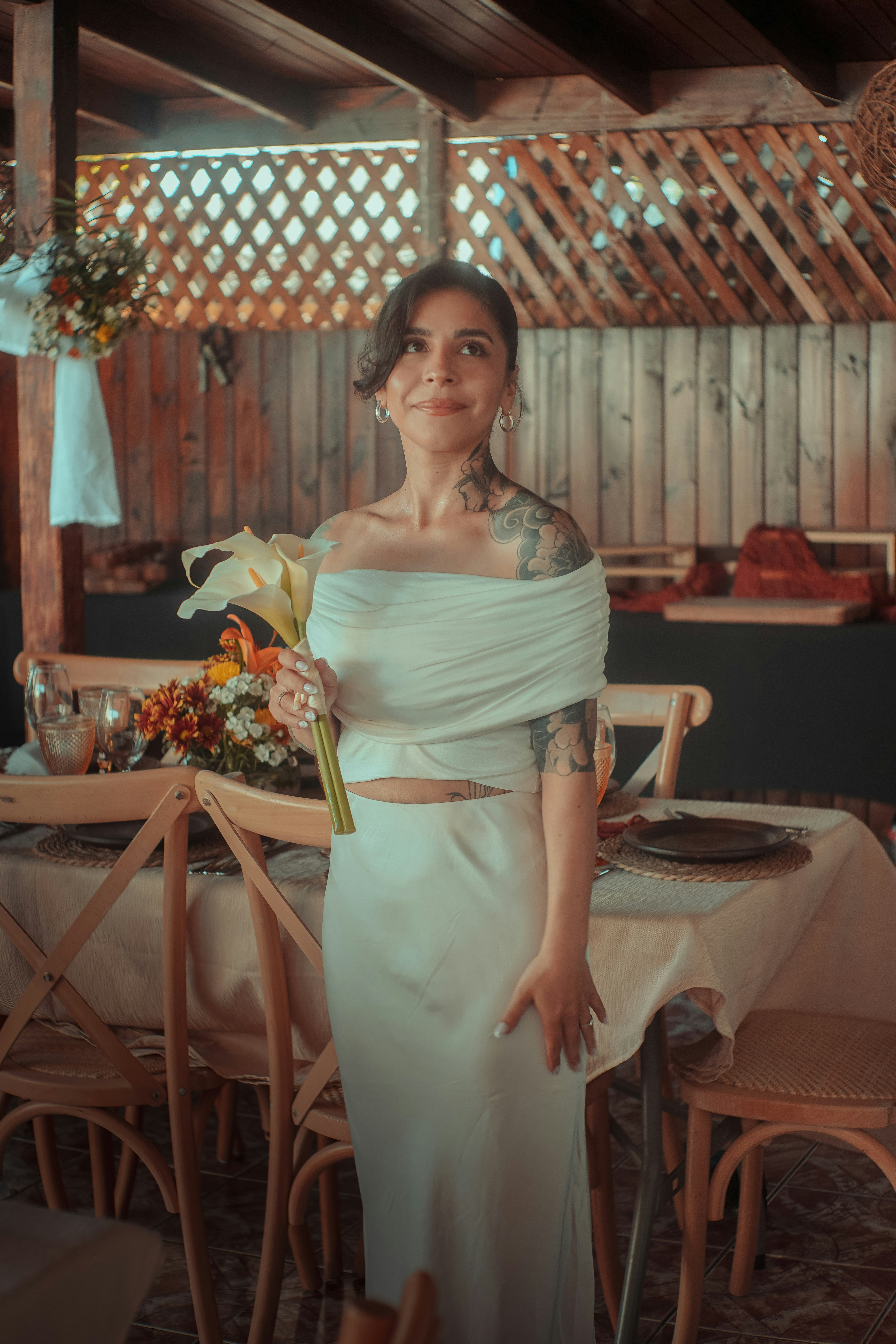 A woman in a white dress holding flowers