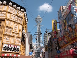 Tsutenkaku tower surrounded by vibrant osaka street signs