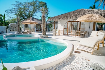 Luxury resort with pool and thatched roof bungalows