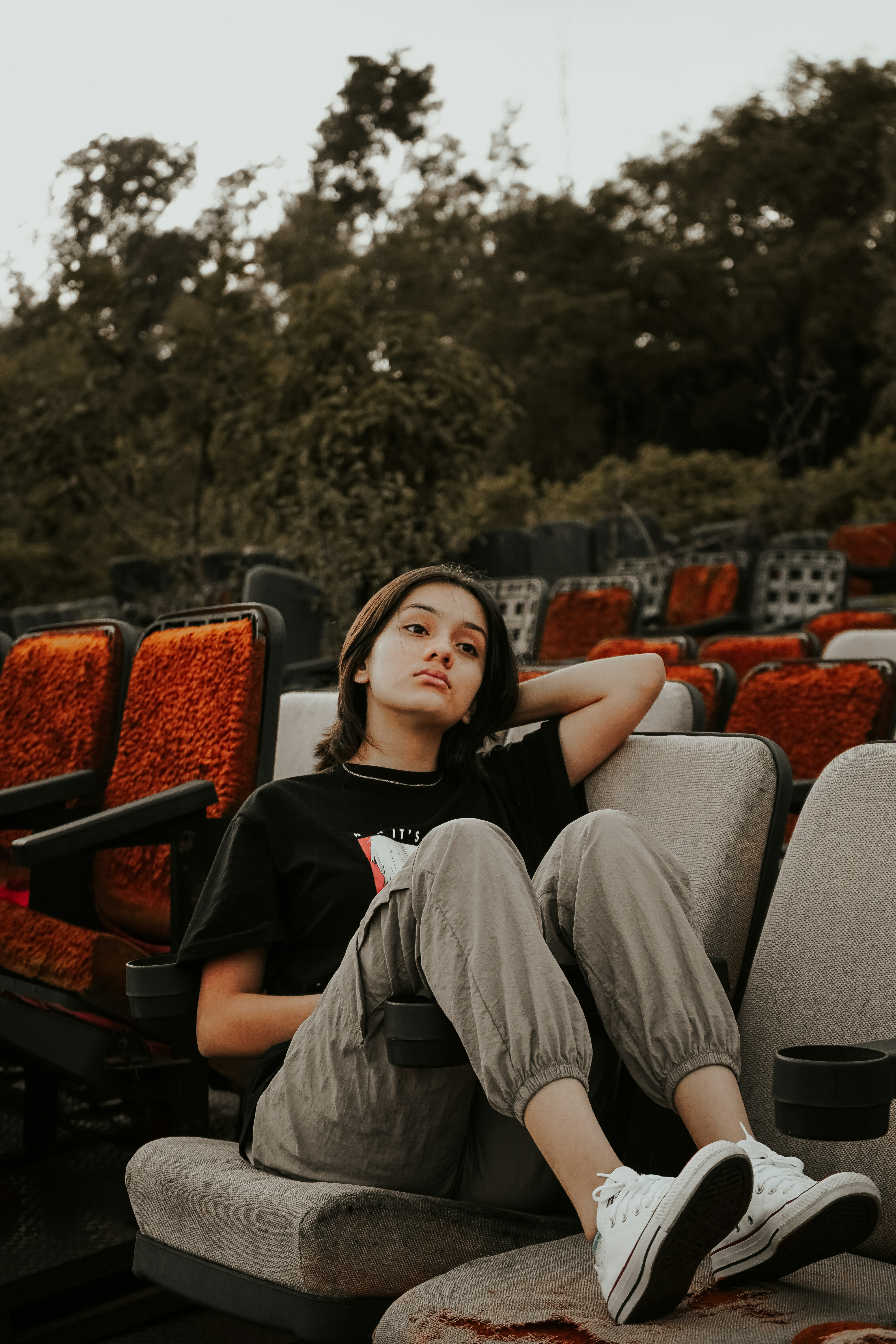 Young woman sitting in empty theater seats