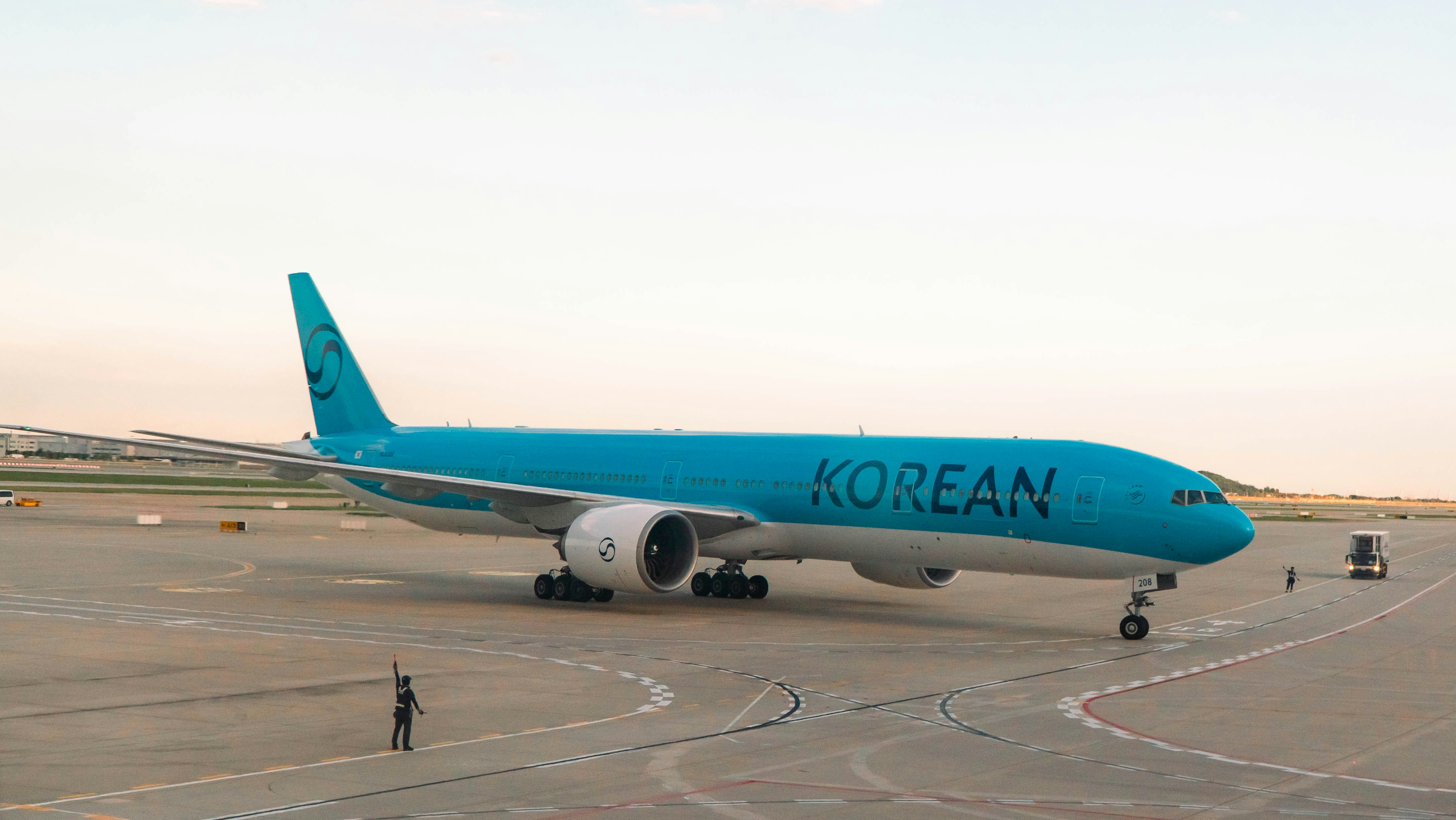 A korean air airplane parked on the tarmac.