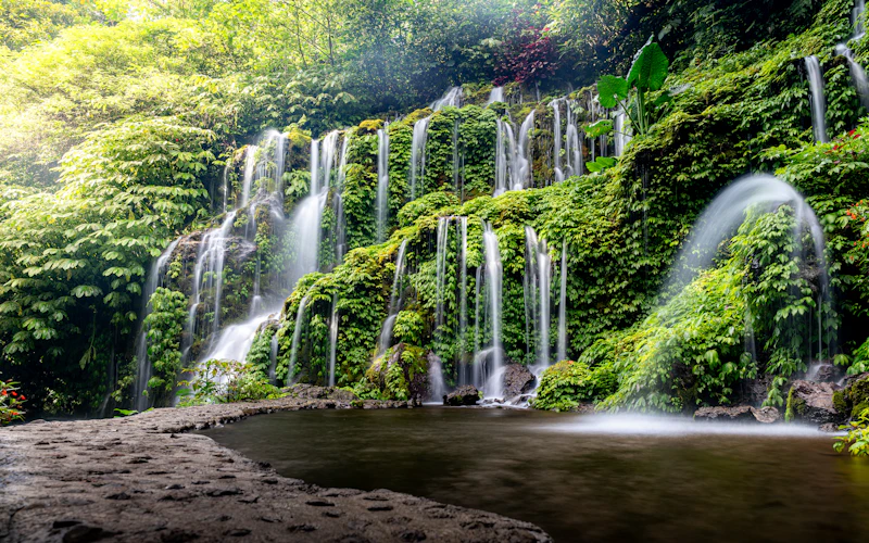 Lush jungle waterfall cascading into a natural pool