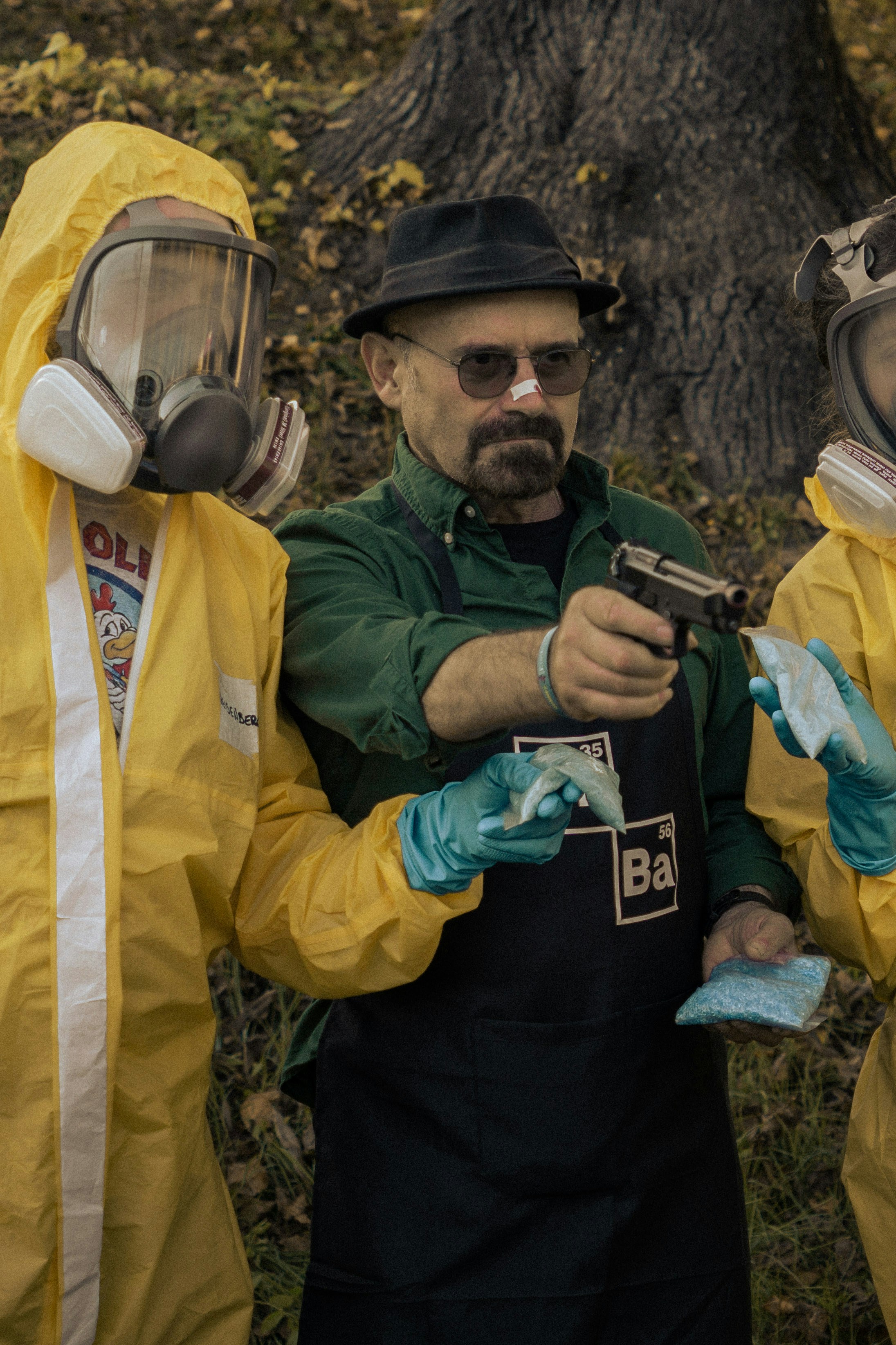 Man in hazmat suits holding blue crystals and gun