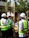 Three people in hard hats and vests talking.