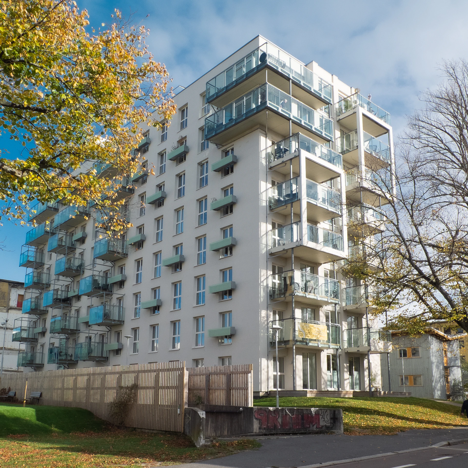 Modern apartment building with balconies in autumn
