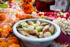 Bowl of lotus buds with marigold garlands
