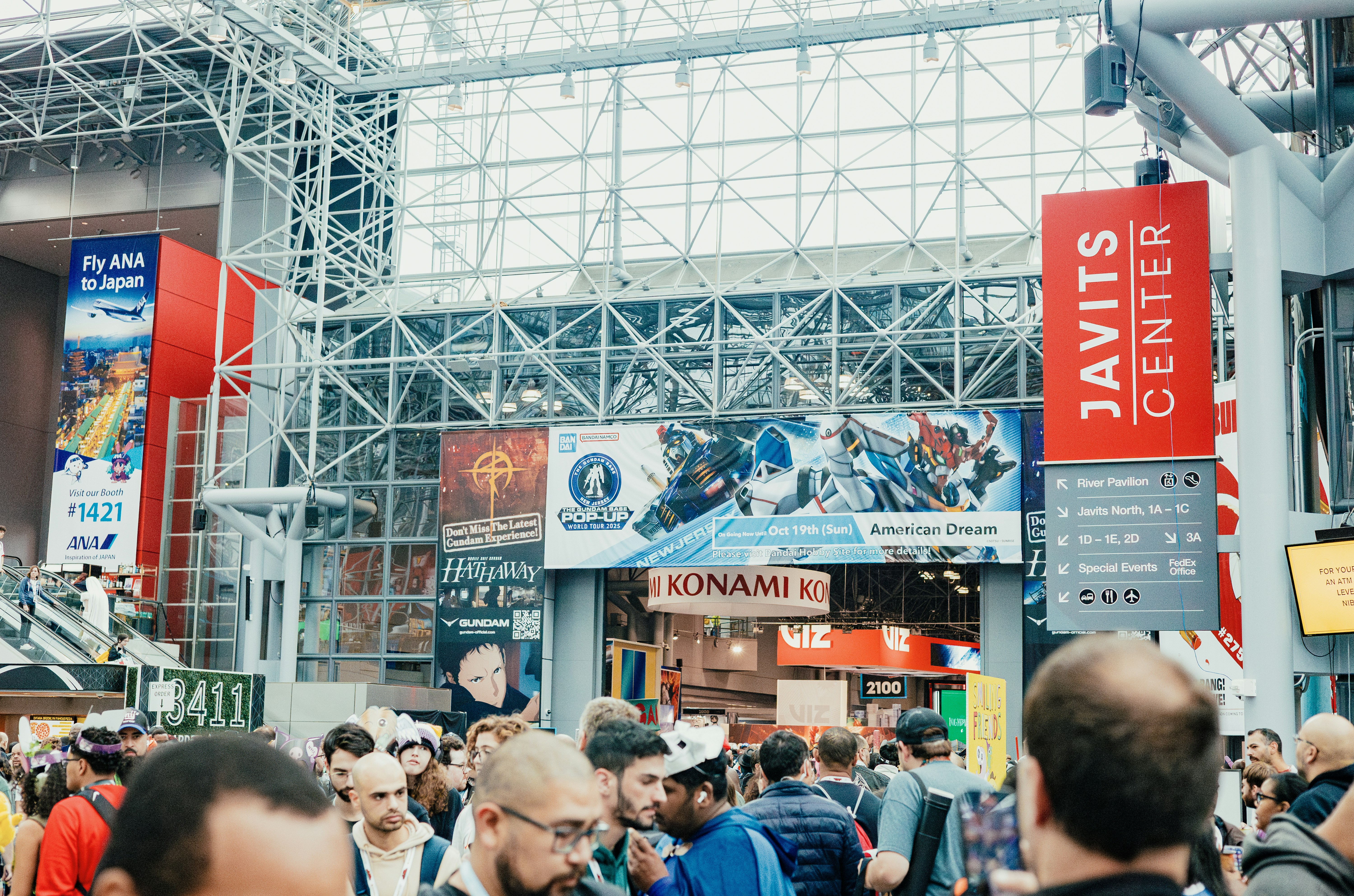 Crowd entering javits center with large advertisements displayed