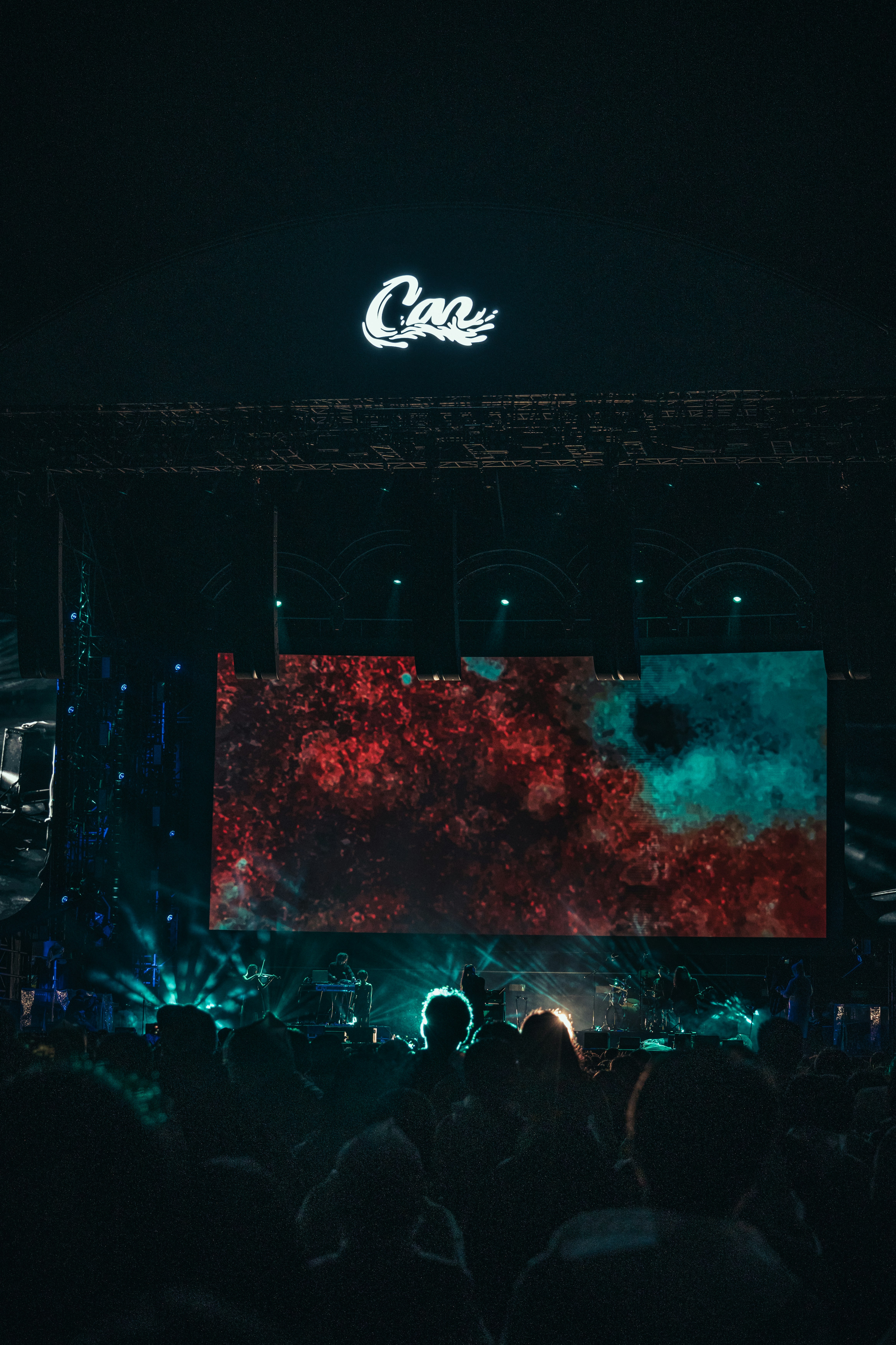 Concert stage with crowd and colorful light display