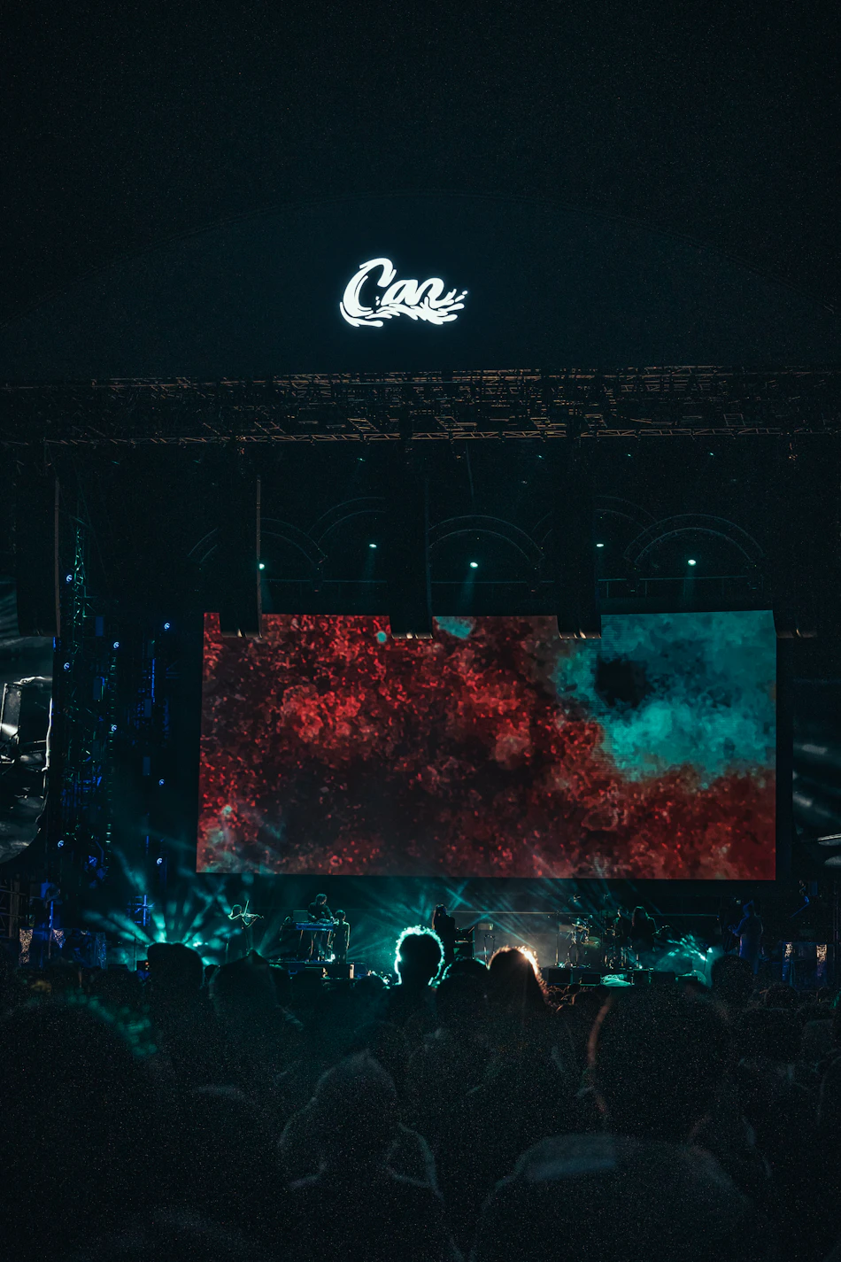 Concert crowd watching a live music performance with colorful stage lights