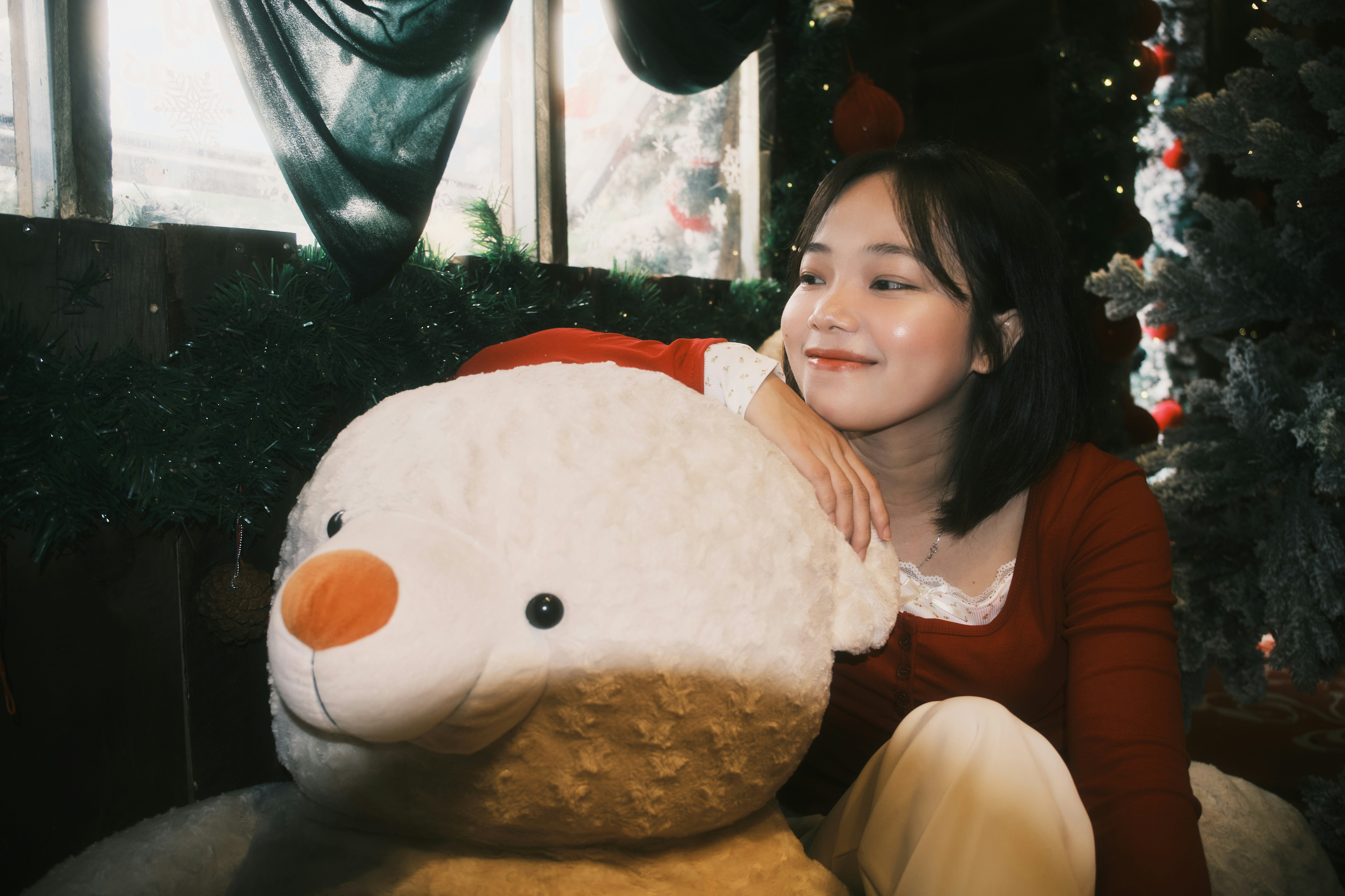 Young woman with a large stuffed snowman