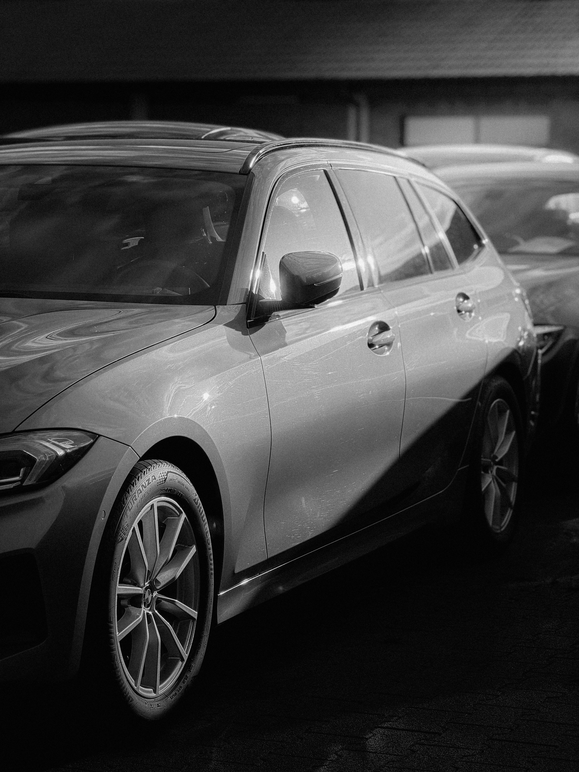 Two cars parked side by side outdoors.