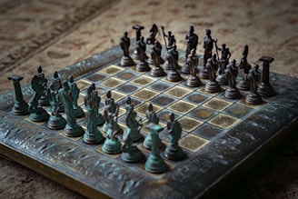 Antique chess set with detailed figures on board.