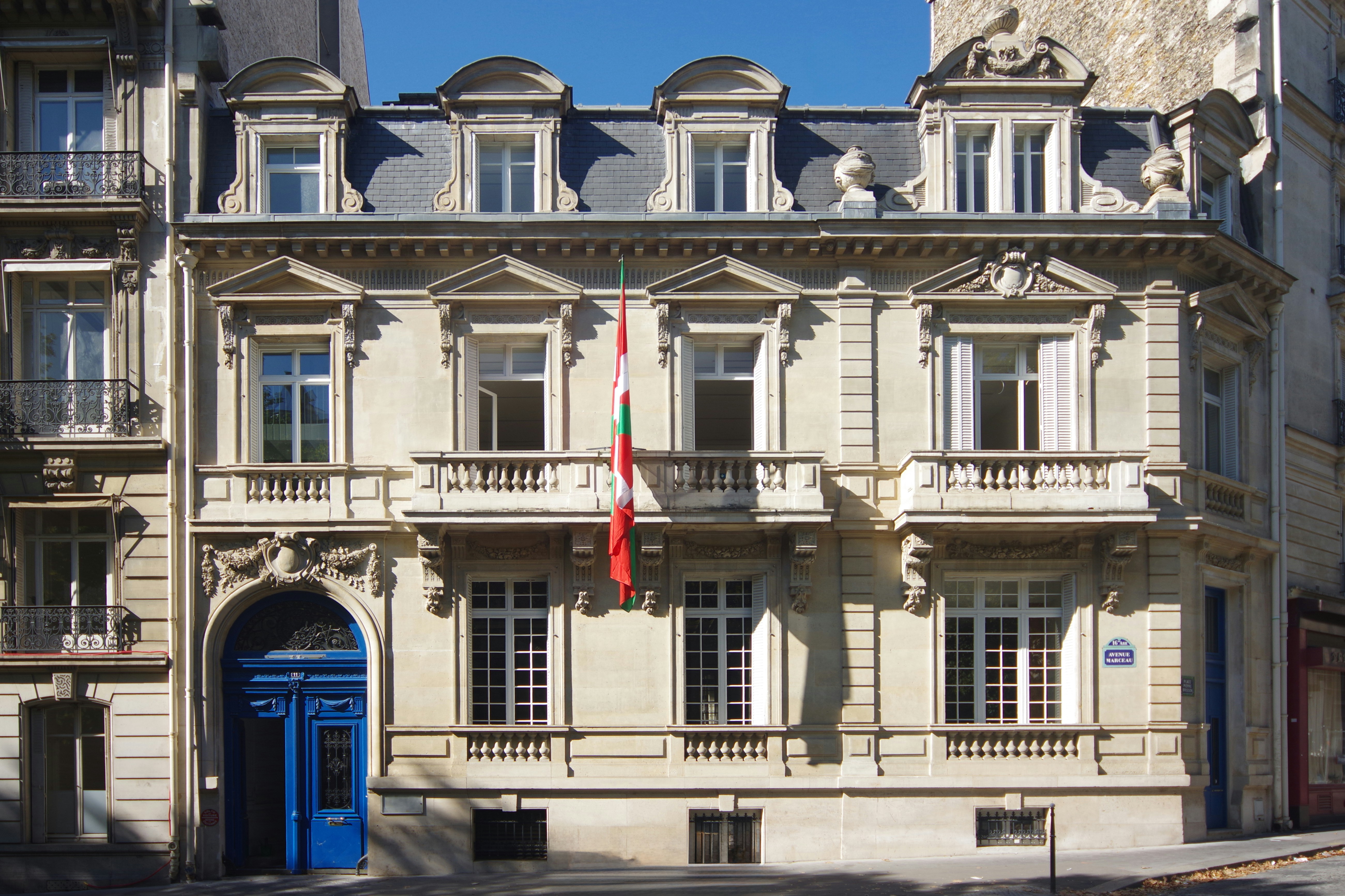 Elegant building with ornate facade and blue doors