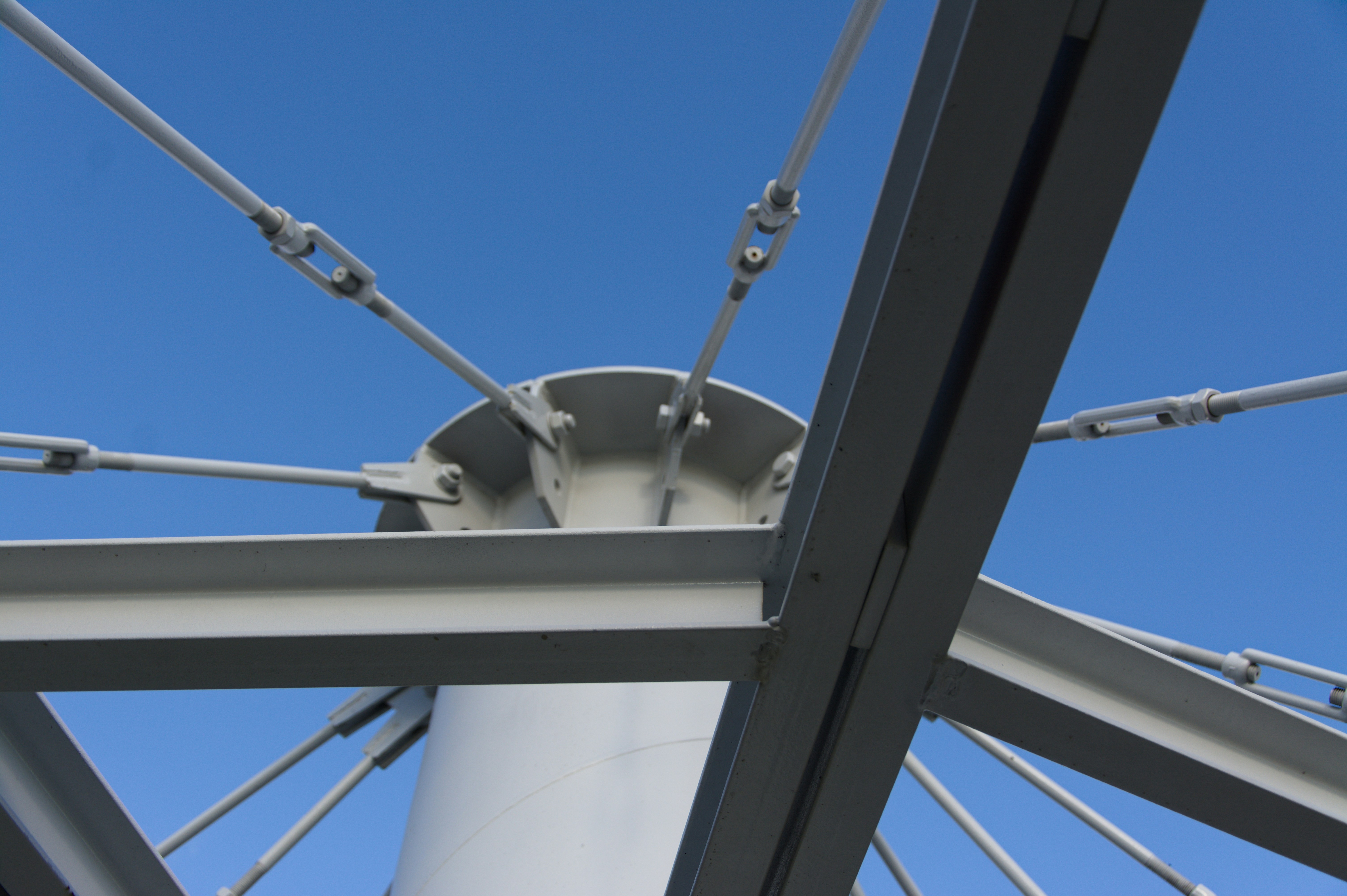 Steel cables and beams against a blue sky