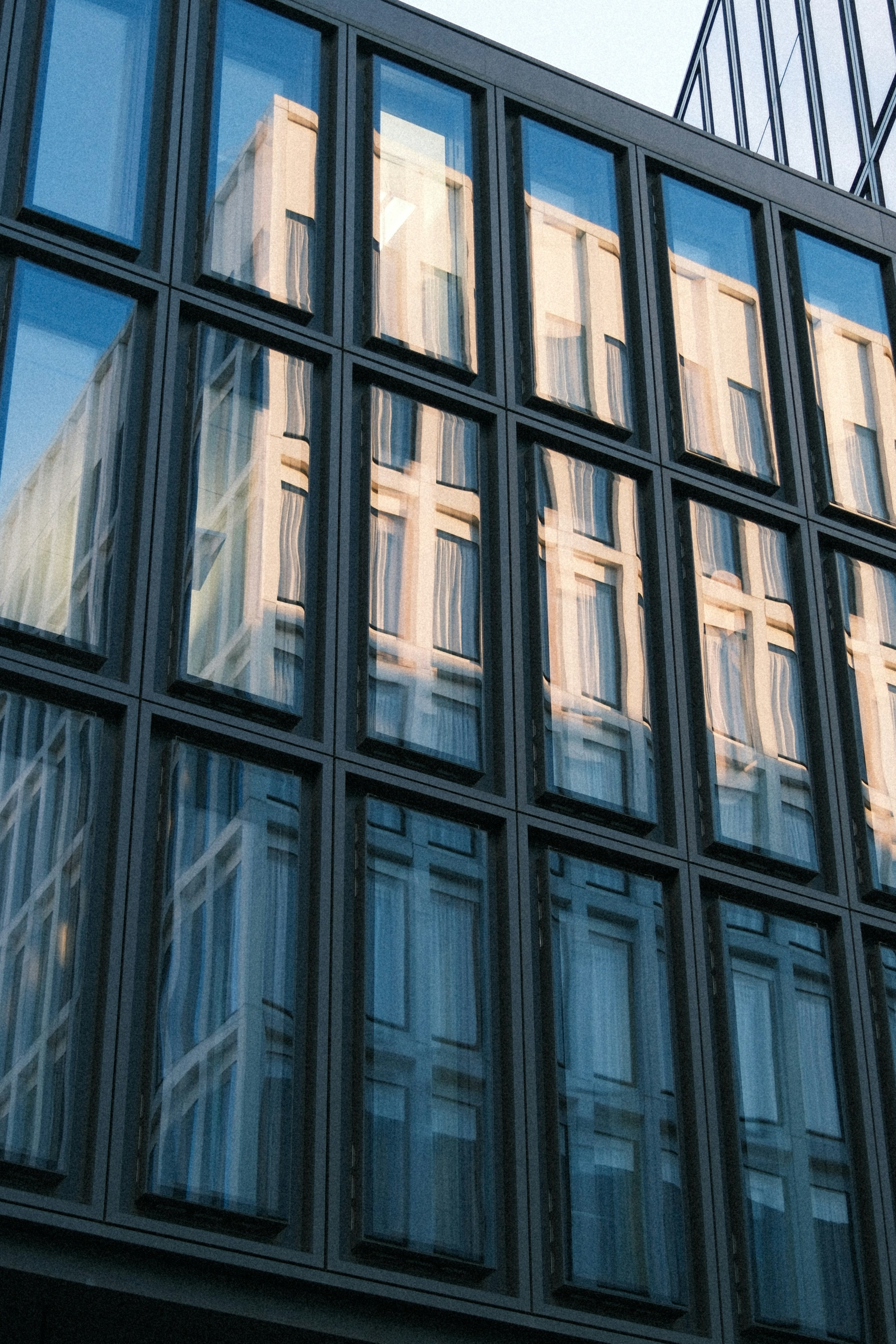 Modern building facade with reflections in windows