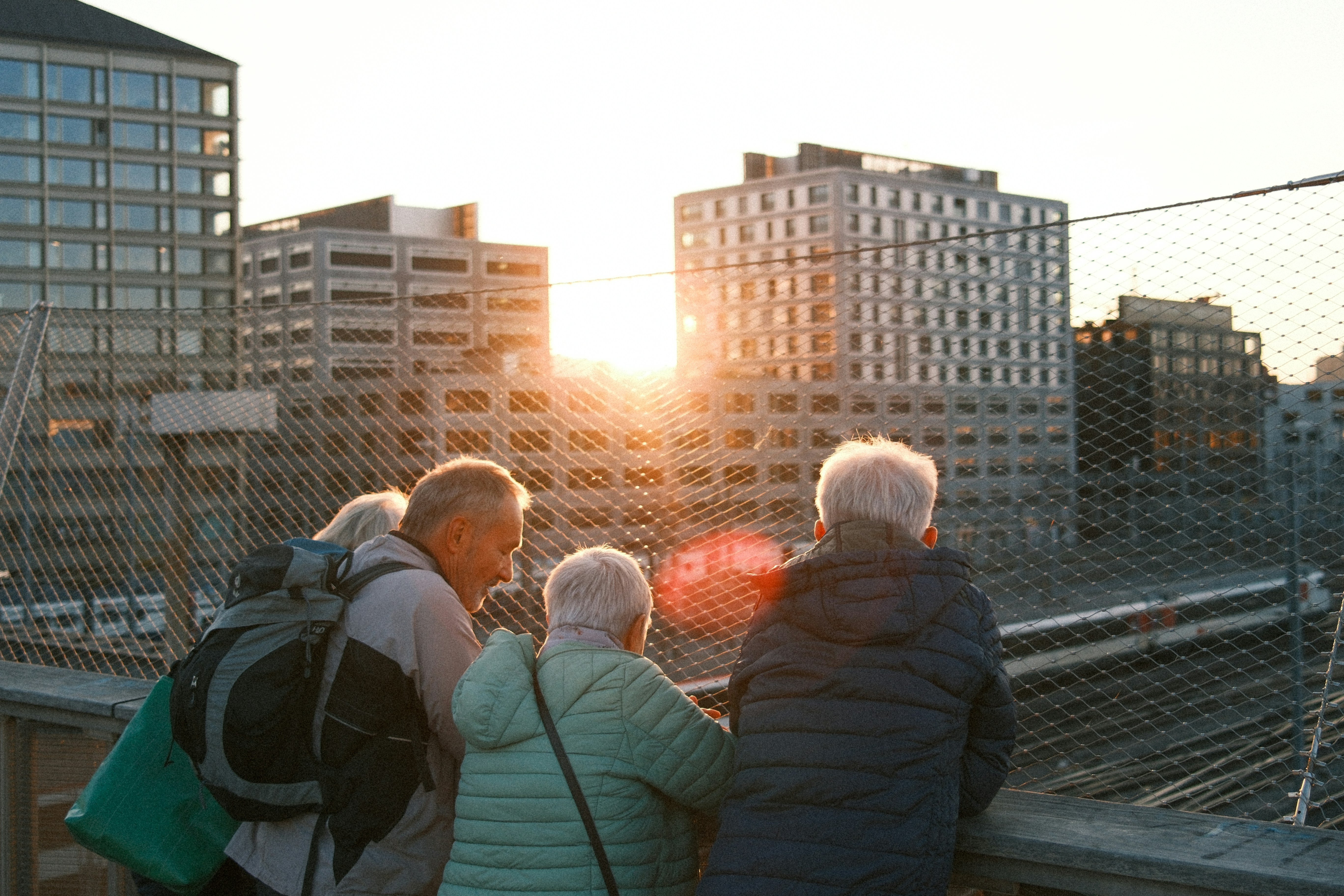 Travelers enjoying the sunset from a rooftop terrace - the local nyc hostel