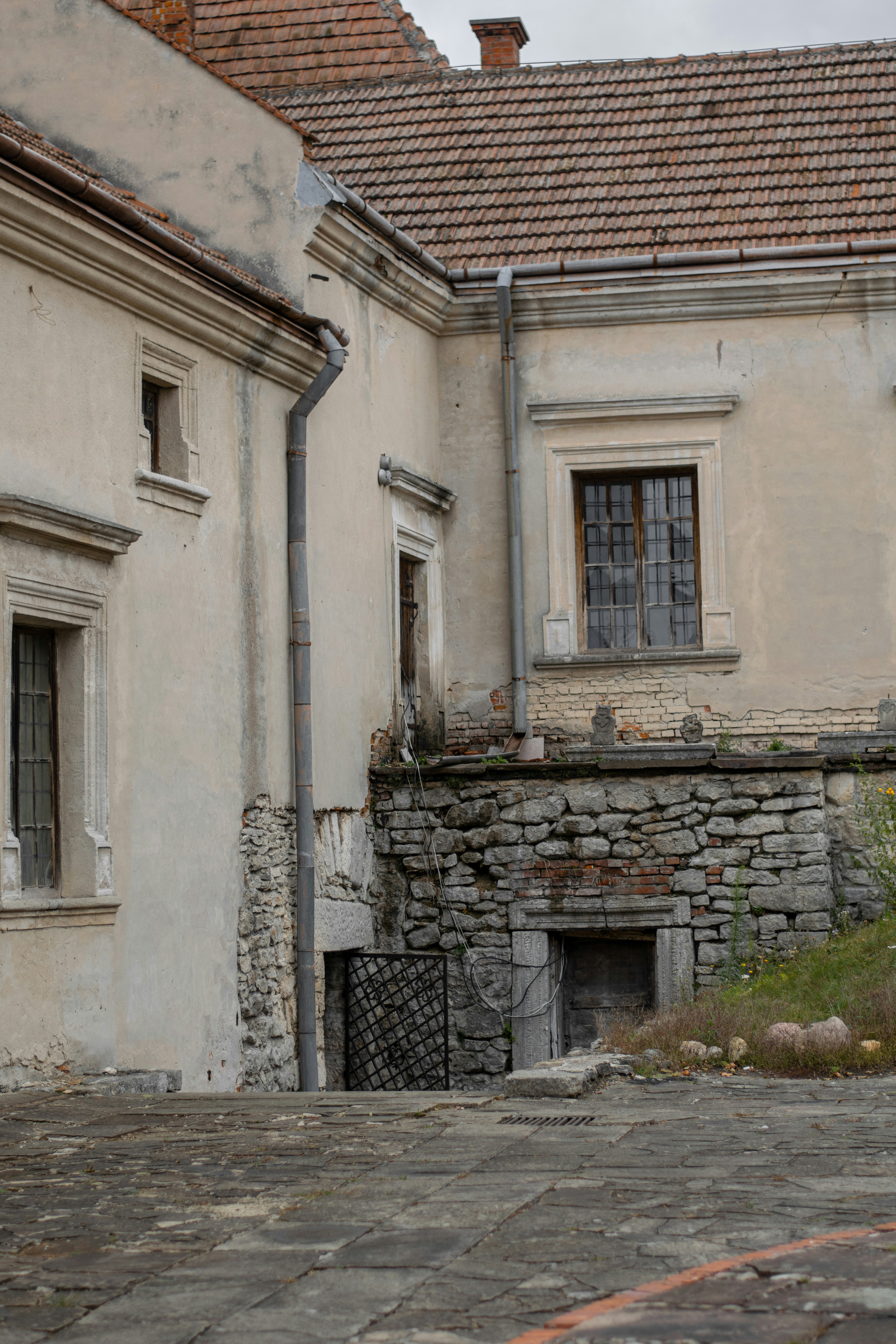Old stone building with weathered walls and windows