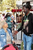 Man talking to woman at outdoor market